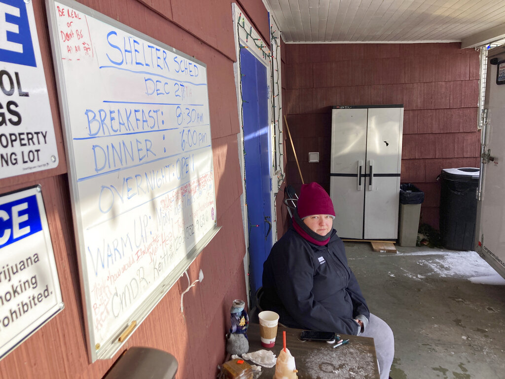 Kaety West sits outside the warming center set up at the West Seattle American Legion Hall Post 160, Monday in Seattle.