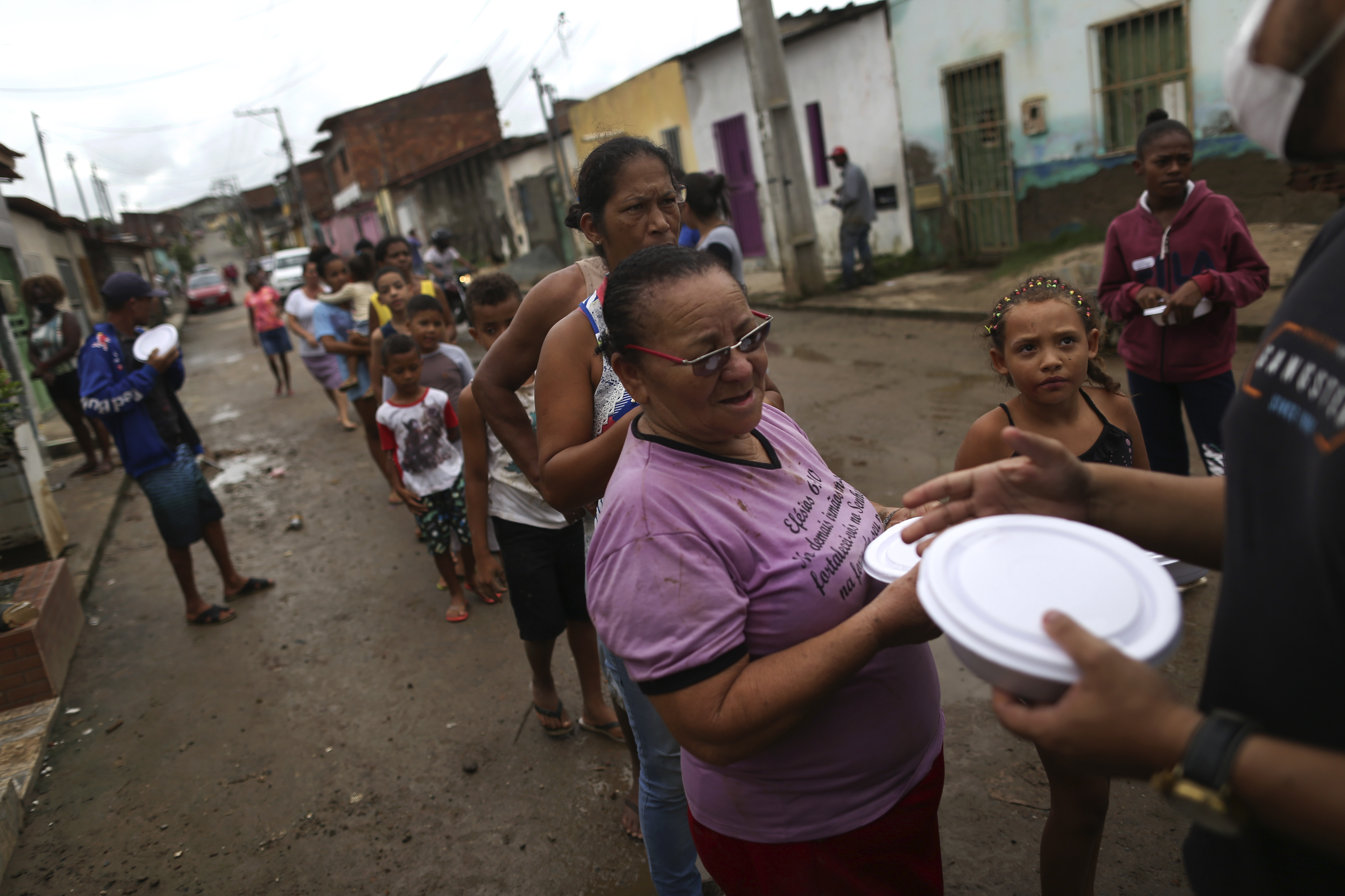 Residents line up for donated food in Itapetinga, Bahia state, Brazil,