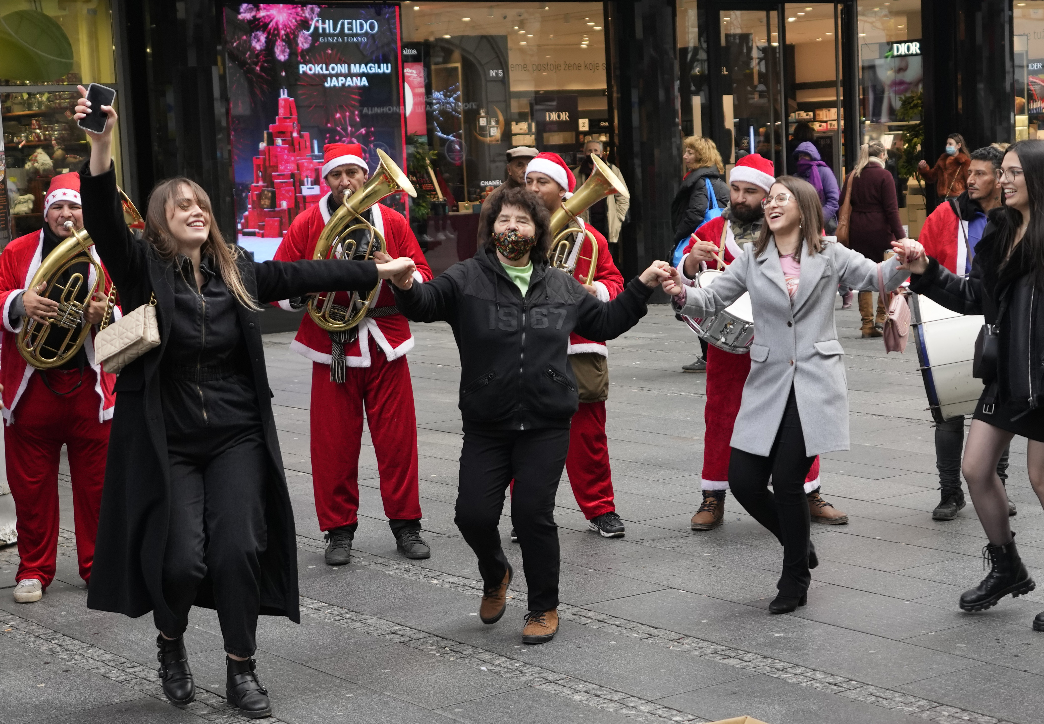People dance the traditional kolo dance on Belgrade's main pedestrian street during New Year's Eve in Serbia