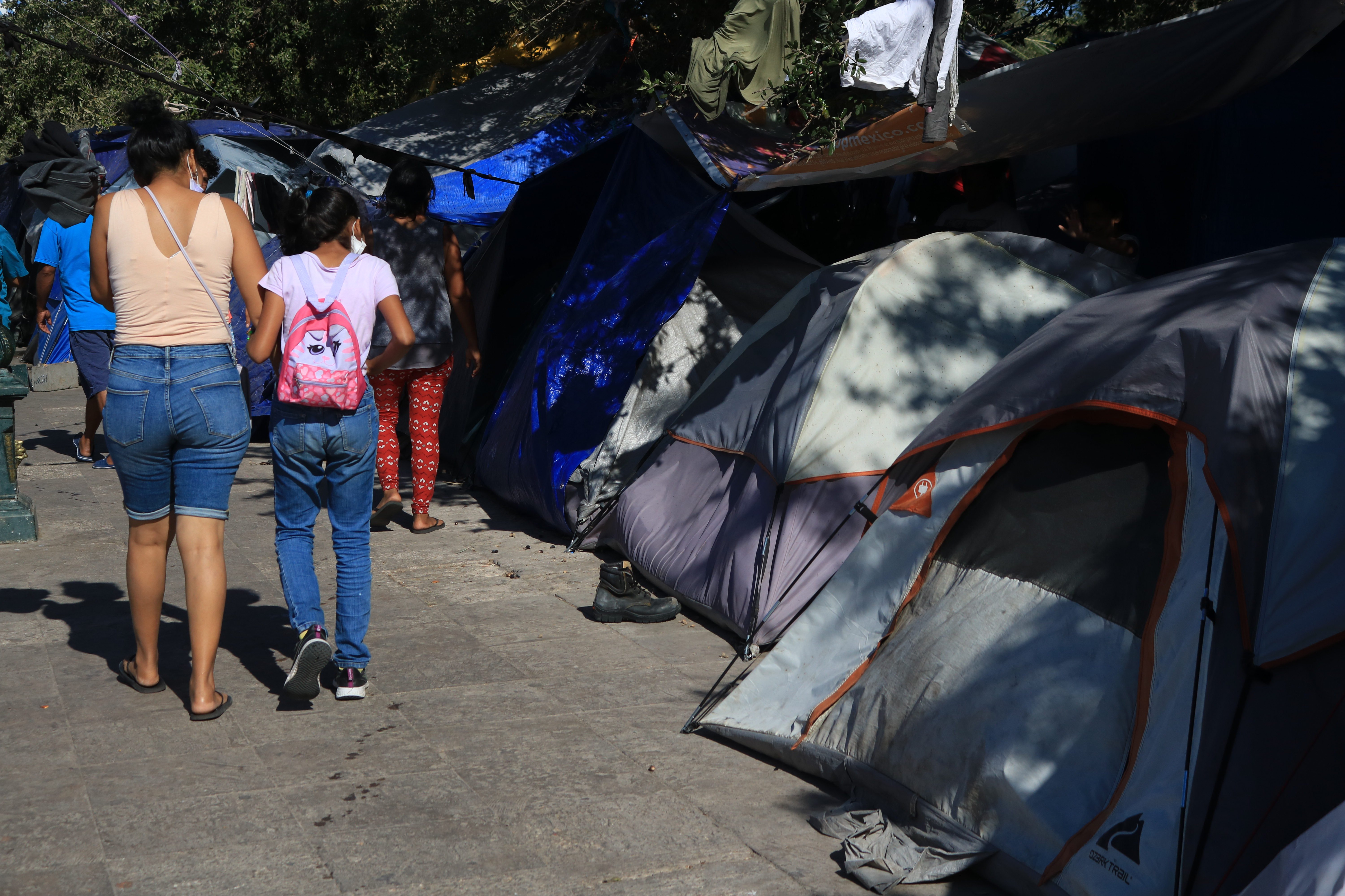 In the Mexican border city of Reynosa, home to nearly one million people, hundreds of families are camped out in a central plaza waiting for a chance to cross the border into the United States [Dylan Baddour/Al Jazeera]