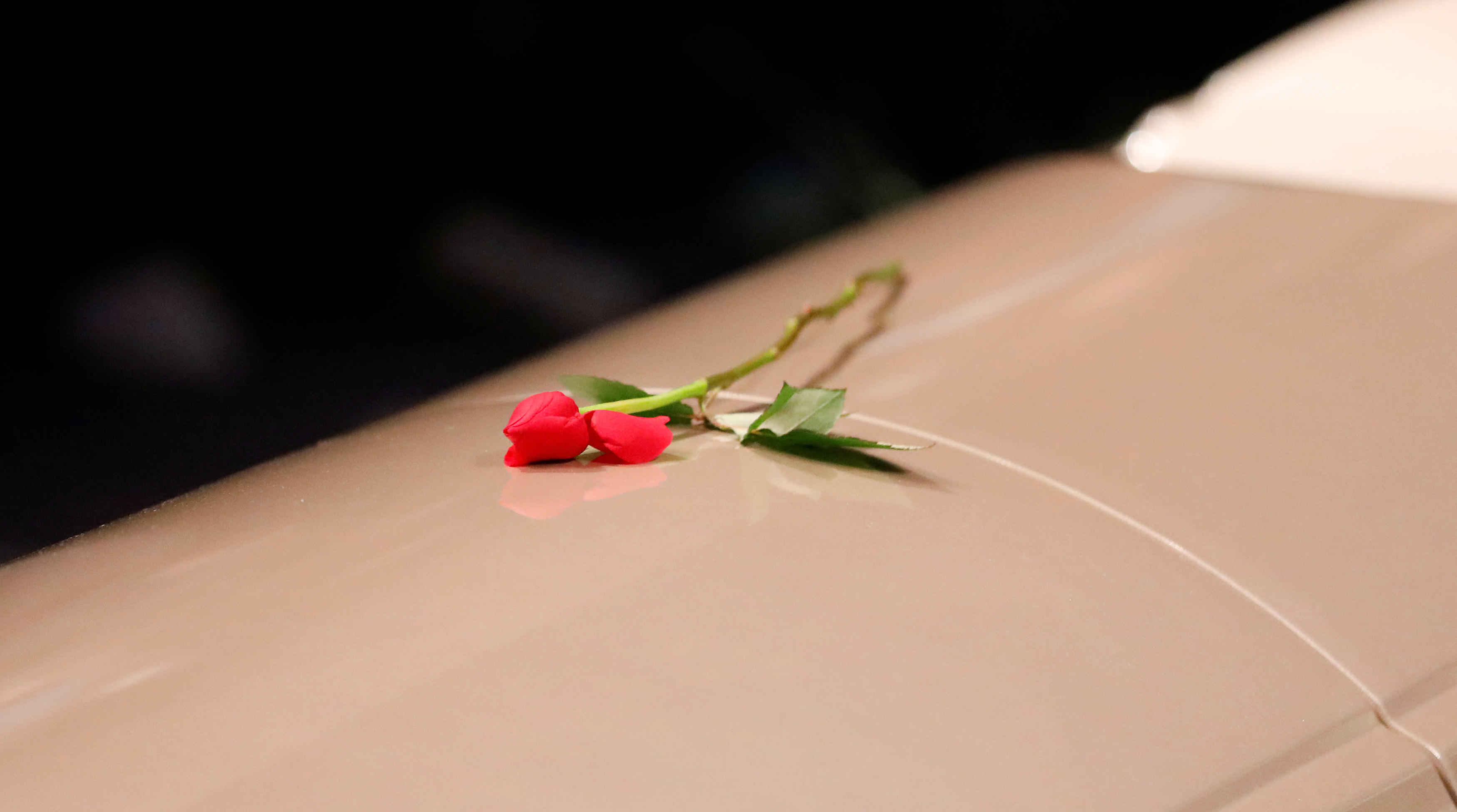 A flower is pictured on a casket during a funeral ceremony for mosque attack victims
