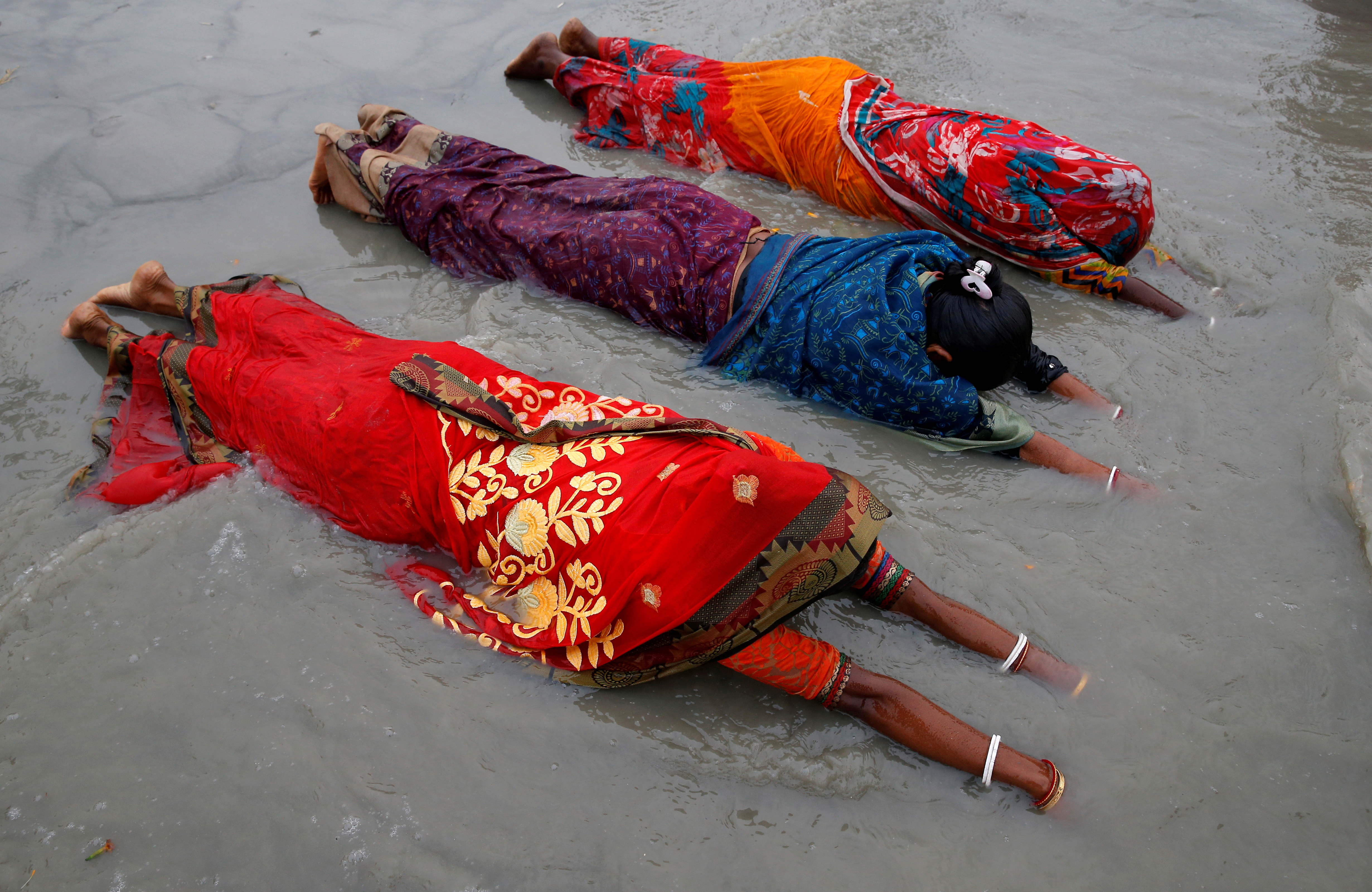 Women worship to Hindu sun god on the banks of Ganges
