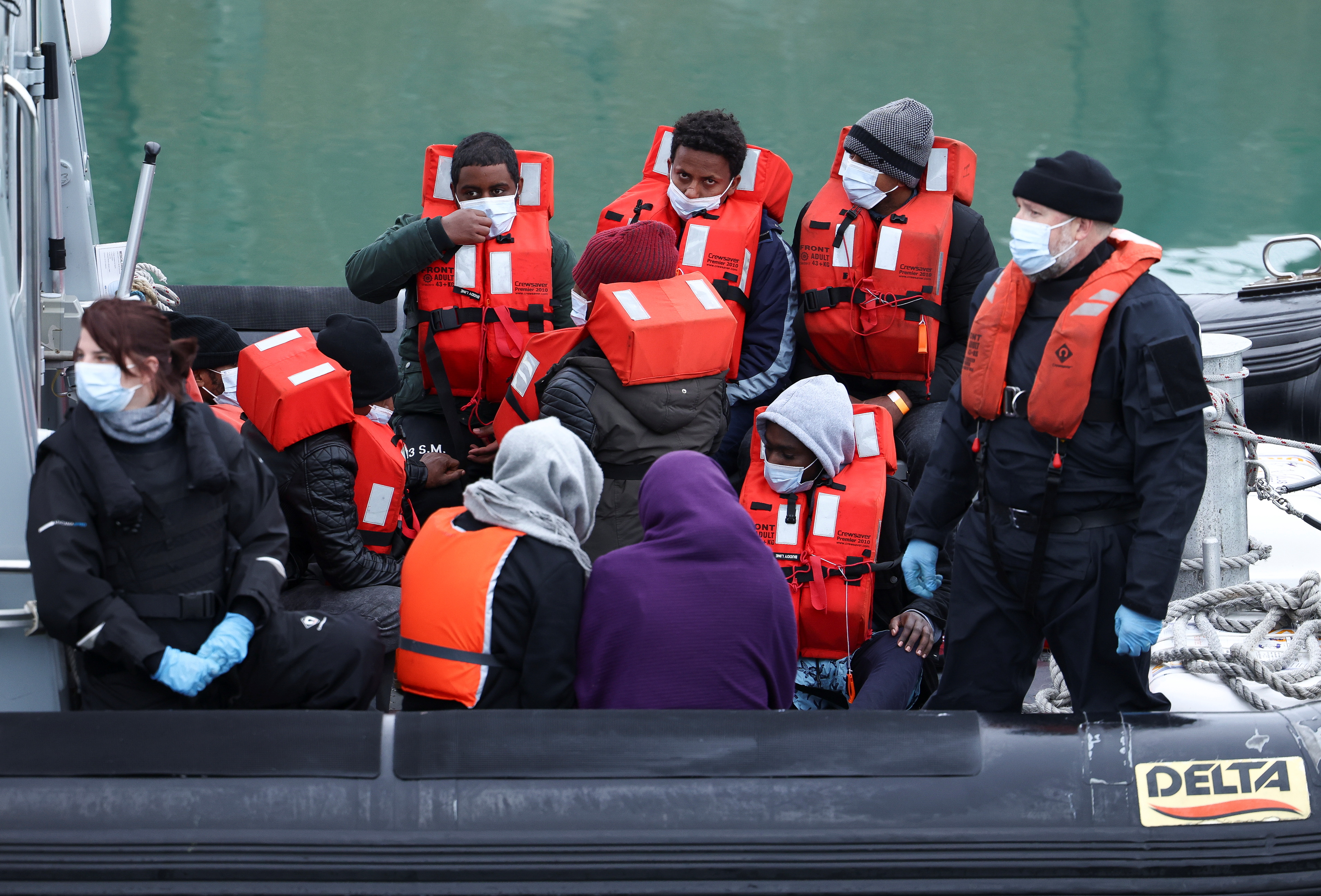 Migrants and refugees are brought into the United Kingdom's Dover harbour onboard a Border Force rescue boat