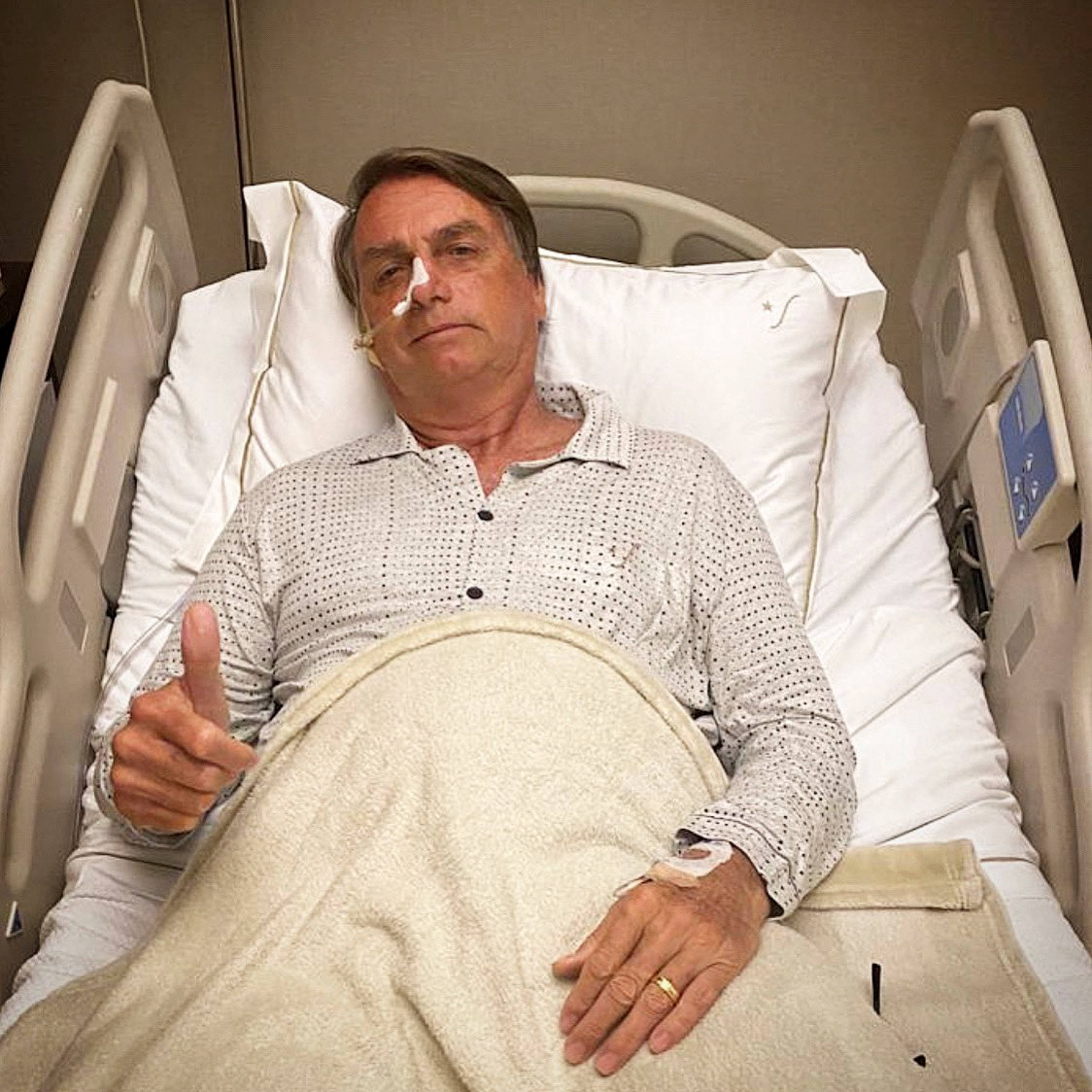 Brazilian President Jair Bolsonaro gestures from a hospital bed in Sao Paulo