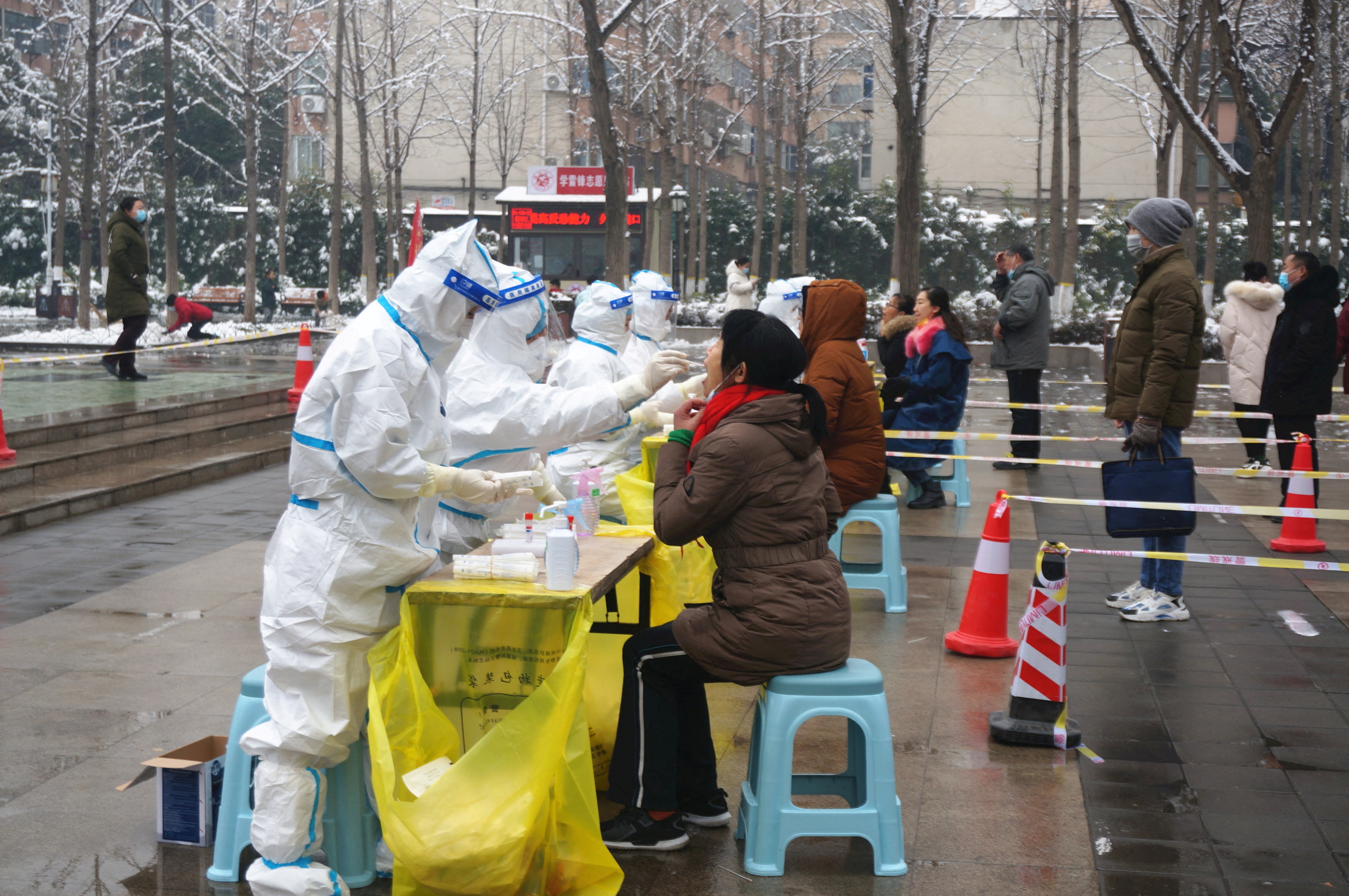Medical workers collect swabs from residents in Zhengzhou, Henan province, China