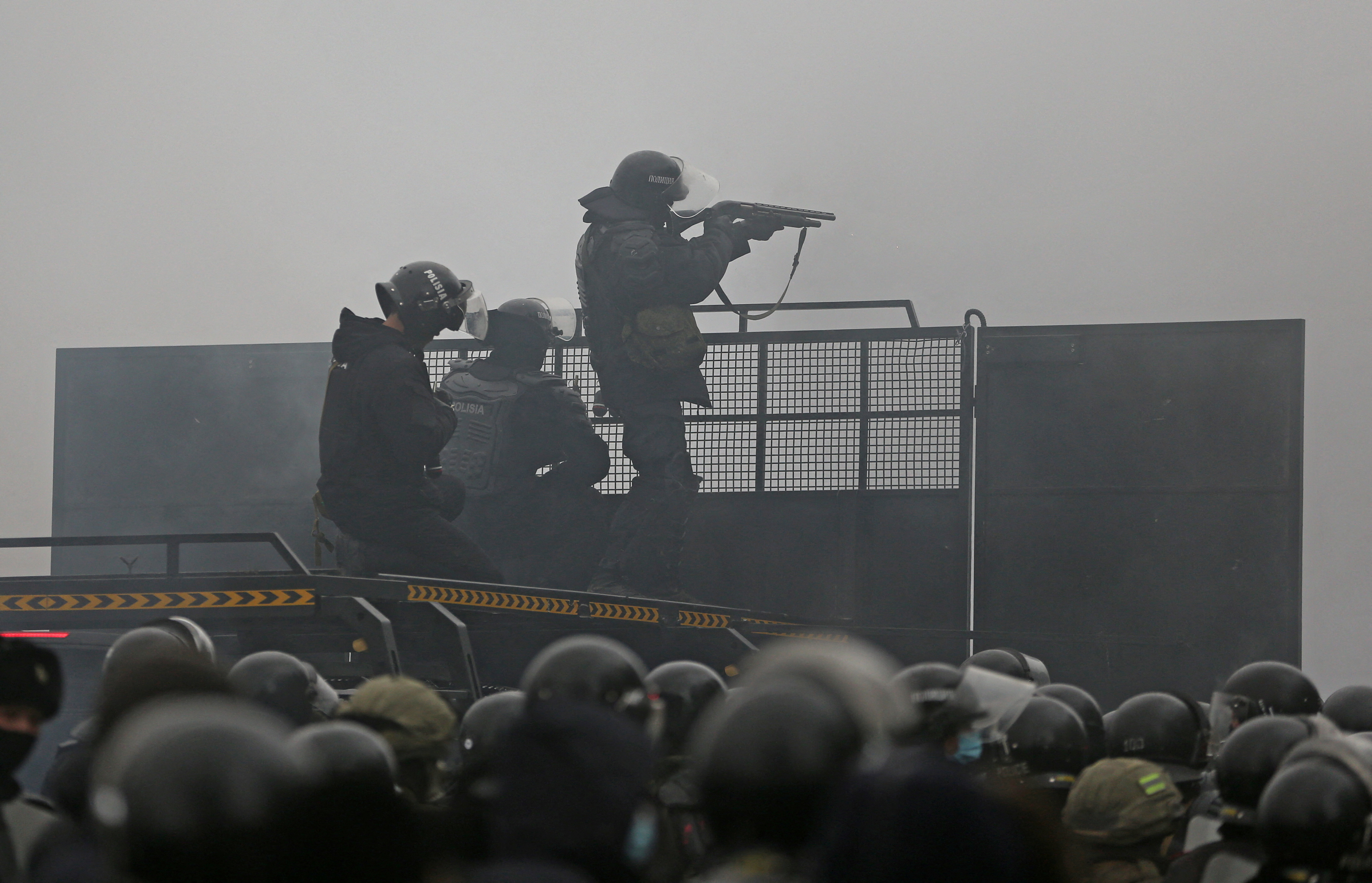 Kazakh security forces are seen on a barricade in Almaty