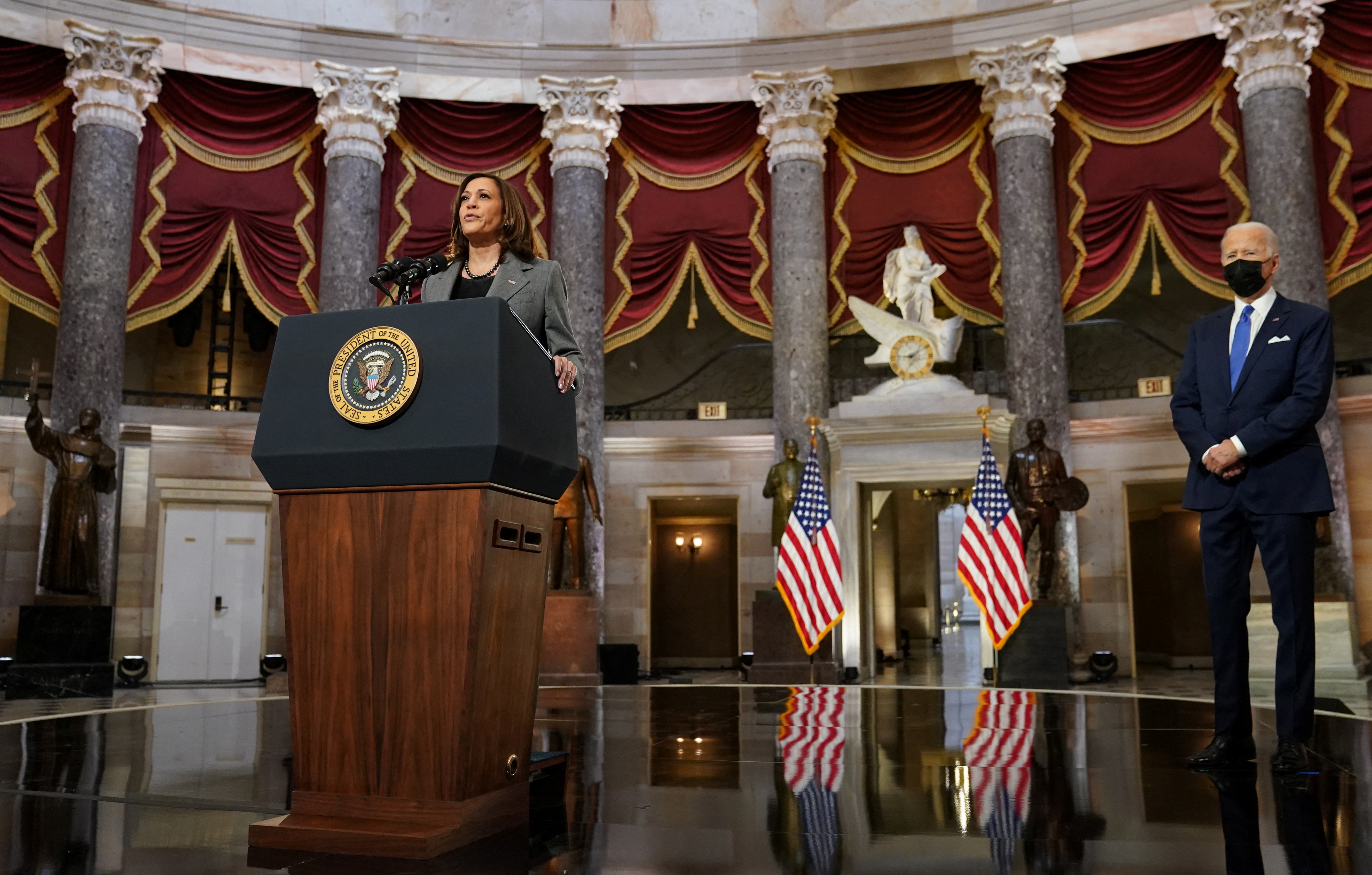US vice president Kamala Harris speaks in Statuary hall in the US Capitol as President Joe Biden looks on