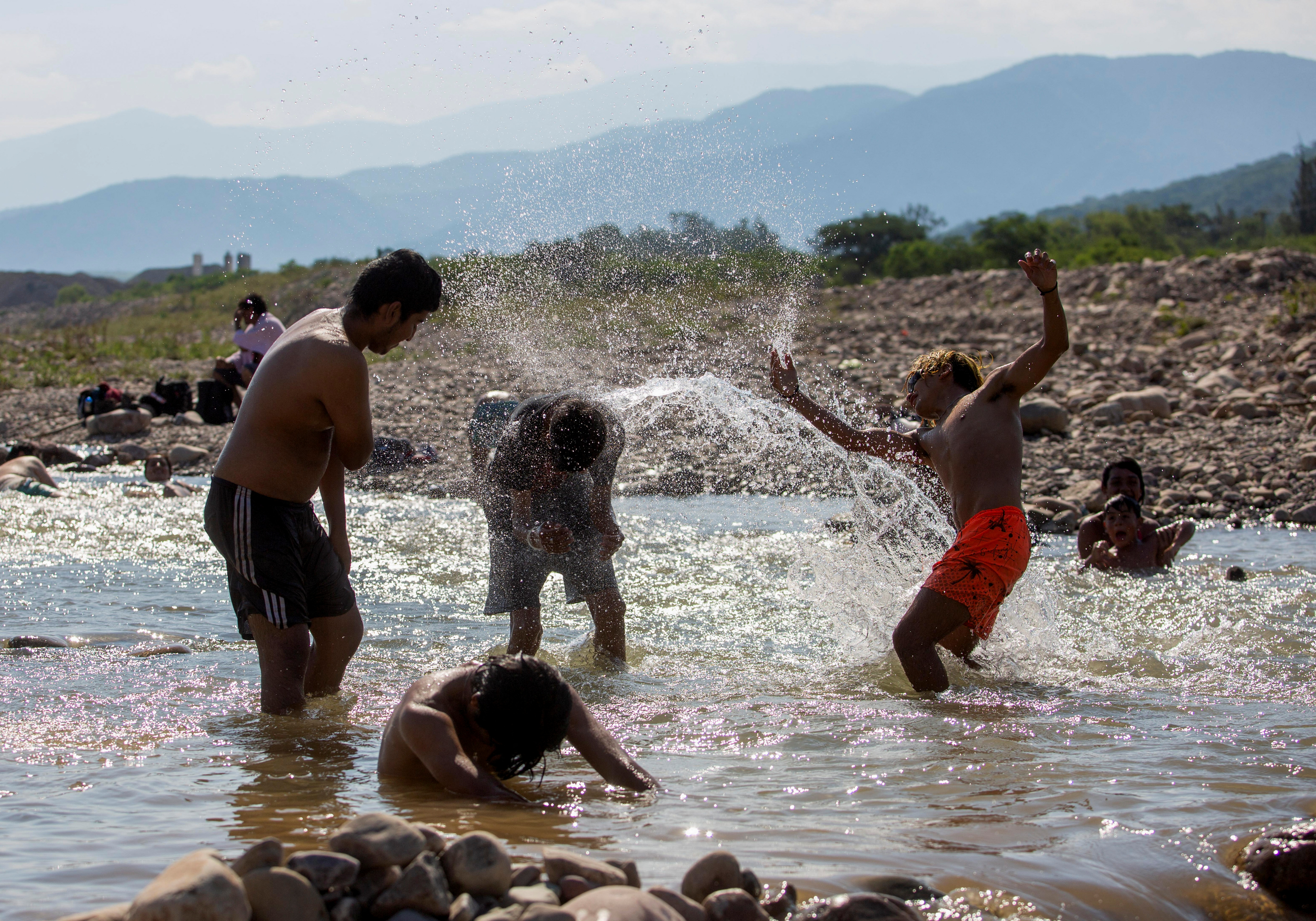 Argentines splash in a river amid record heat