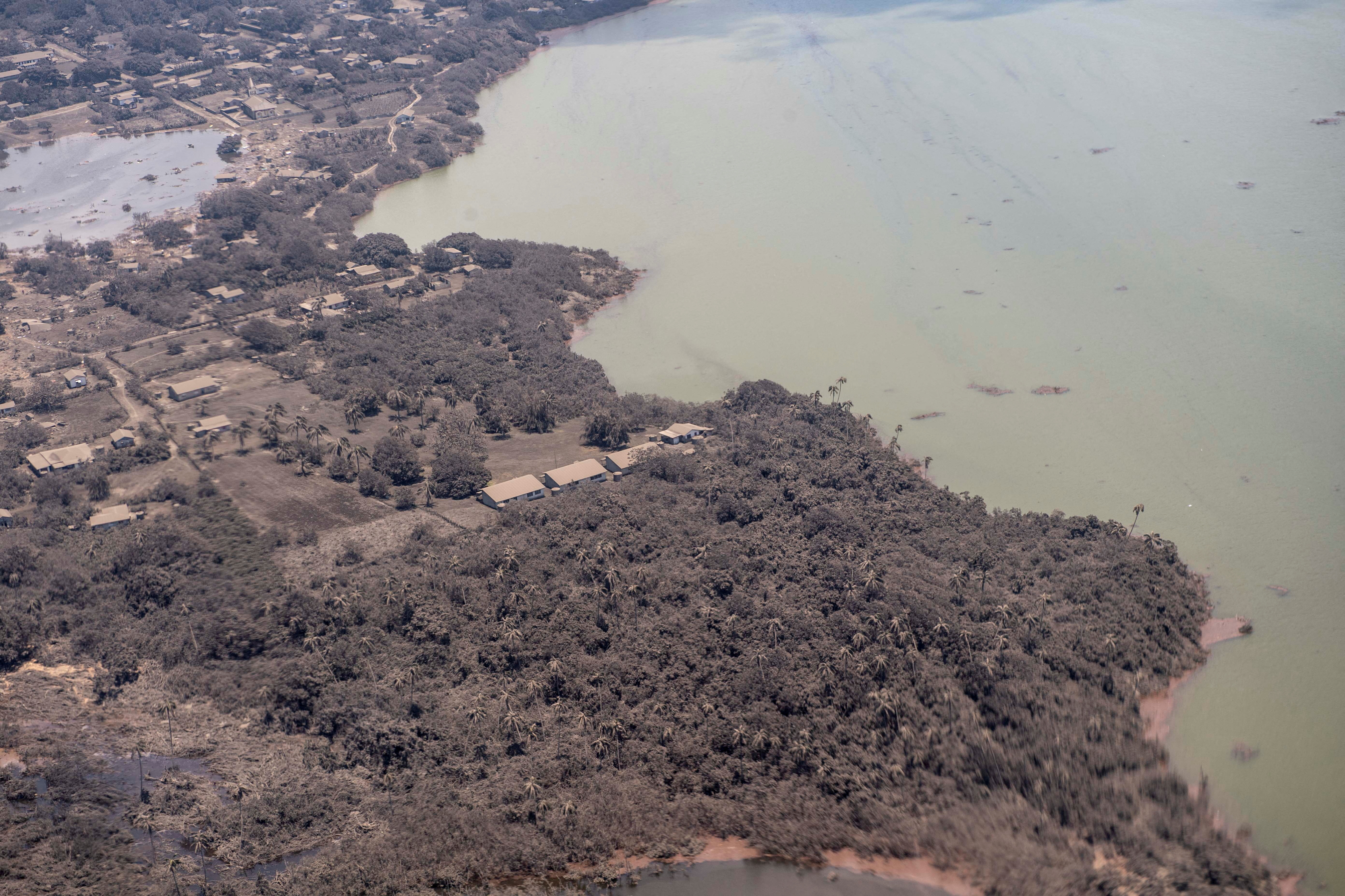 Ash covered homes and vegetation over Nomuka in Tonga