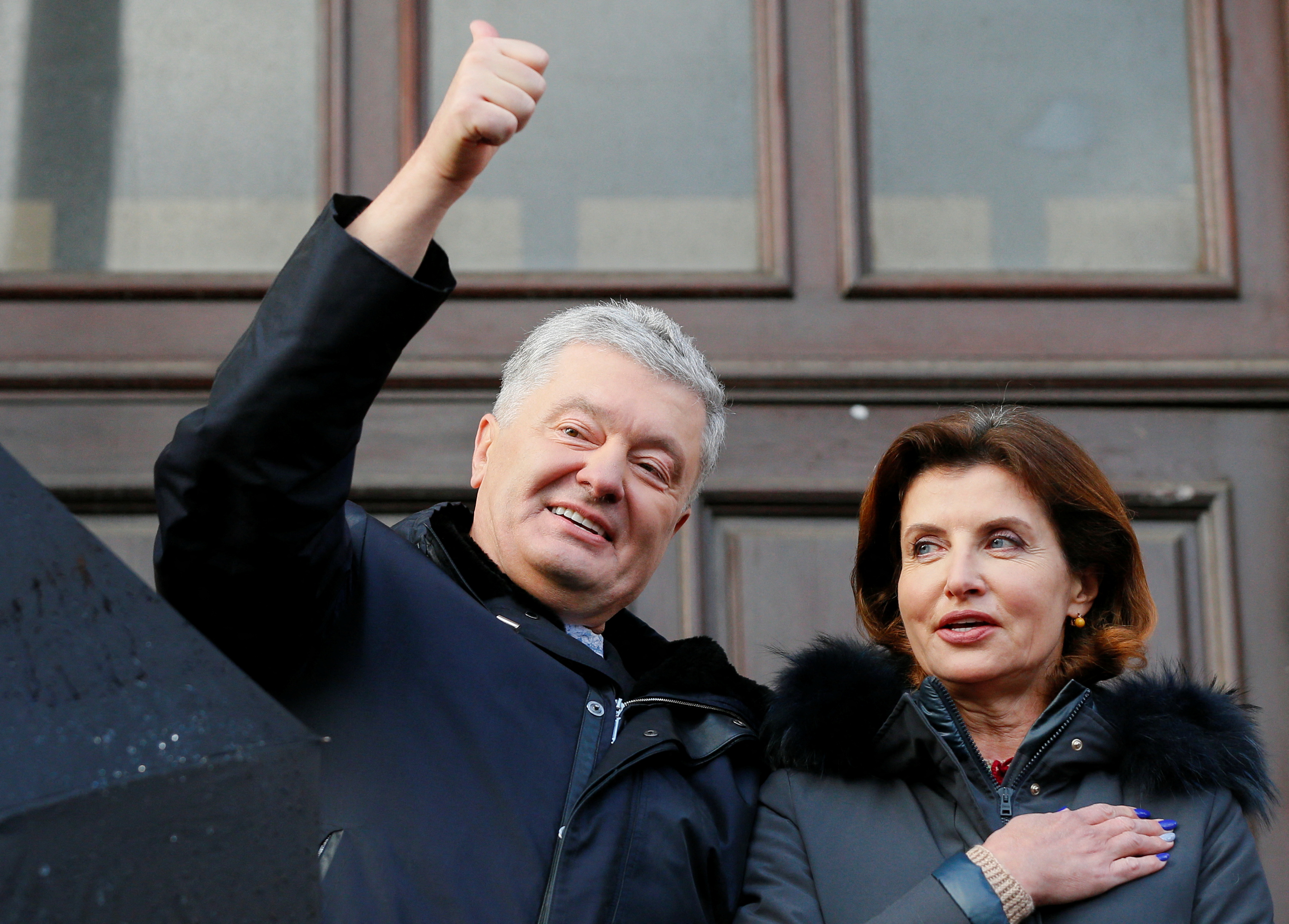 Former Ukrainian President Petro Poroshenko with his wife Maryna outside a court after a hearing in Kyiv, Ukraine