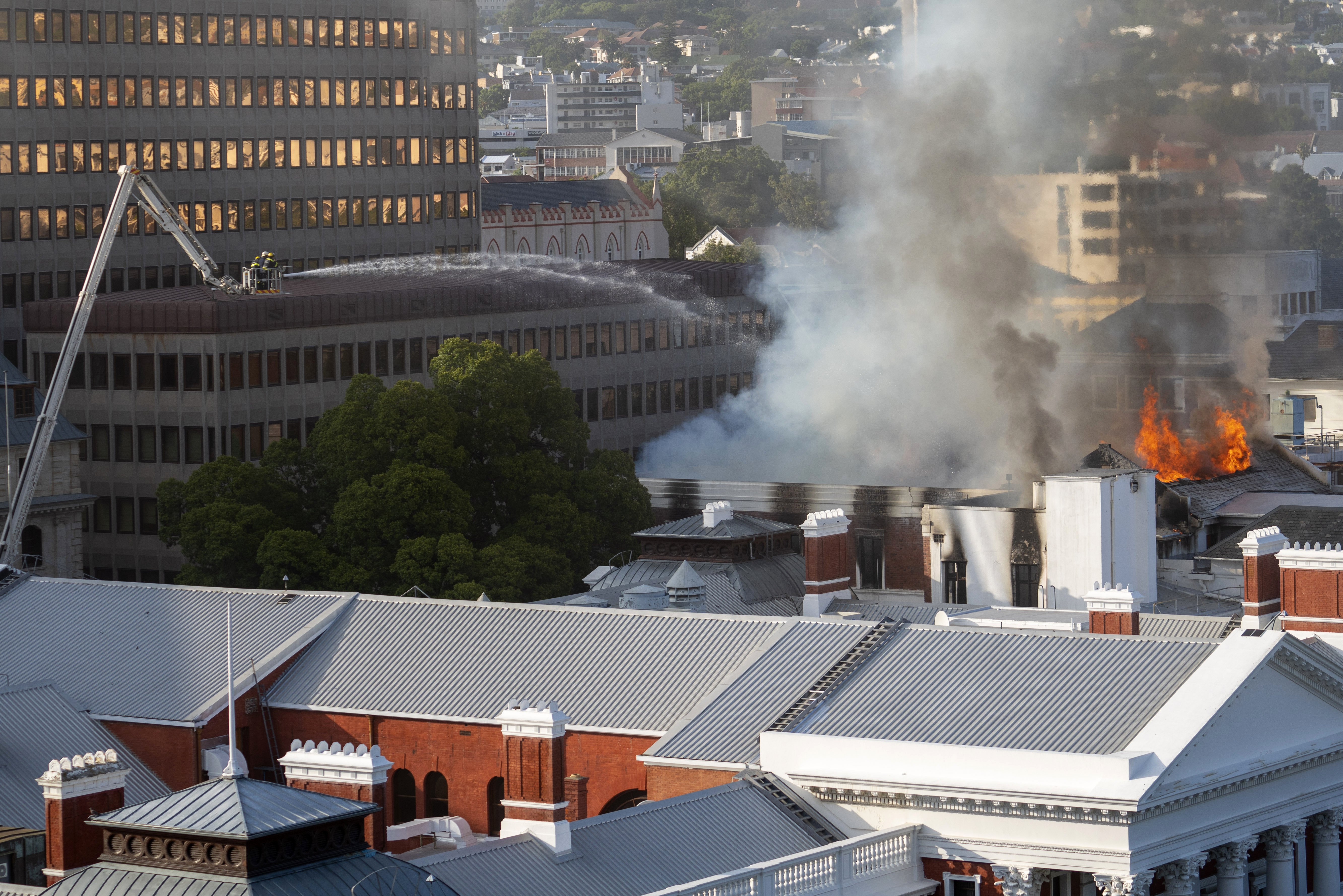 Firemen spray water on flames erupting from the South Africa's Parliament building.