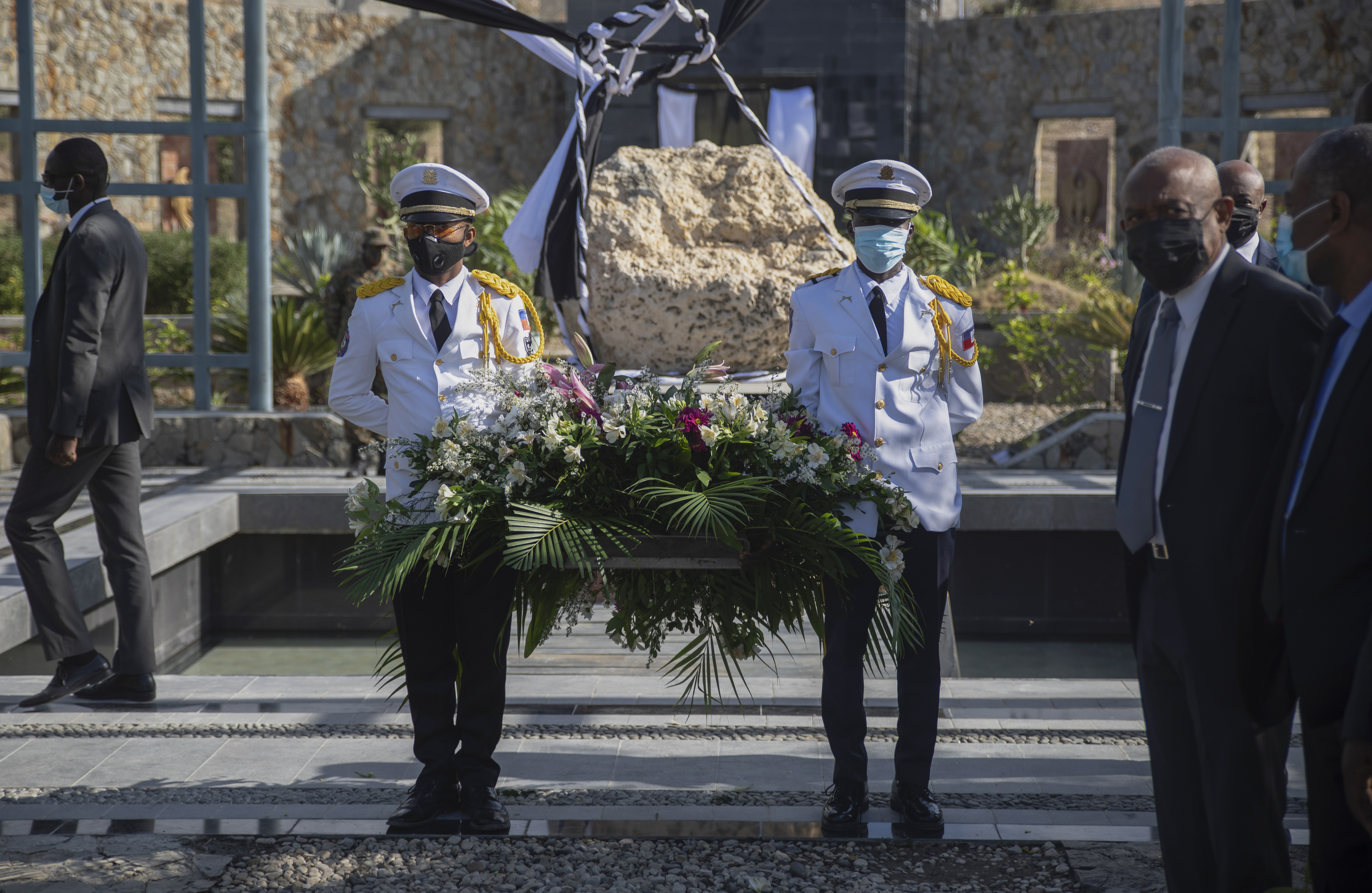 Haitian police officers holding wreath