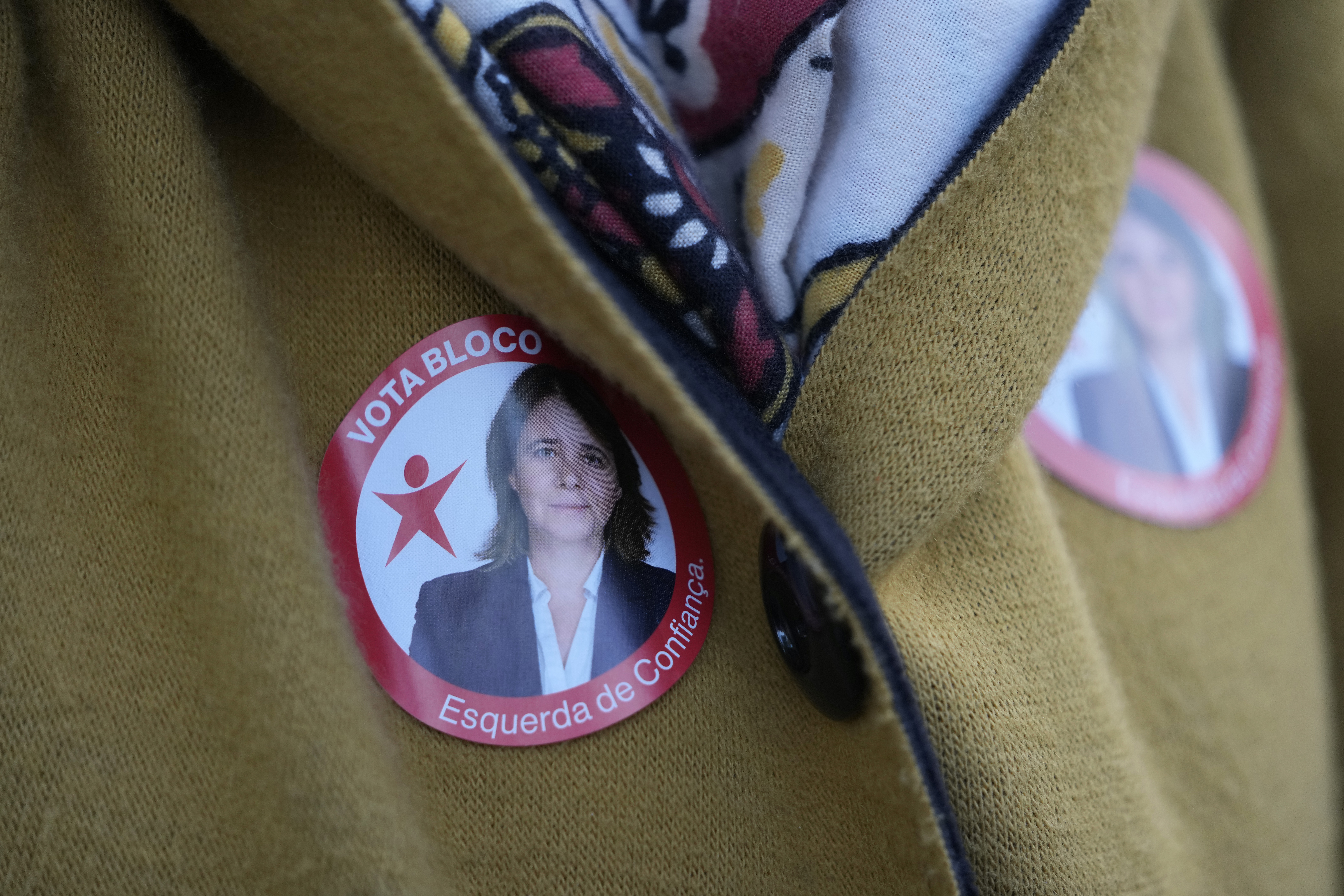 A woman wears stickers with a picture of Left Bloc leader Catarina Martins