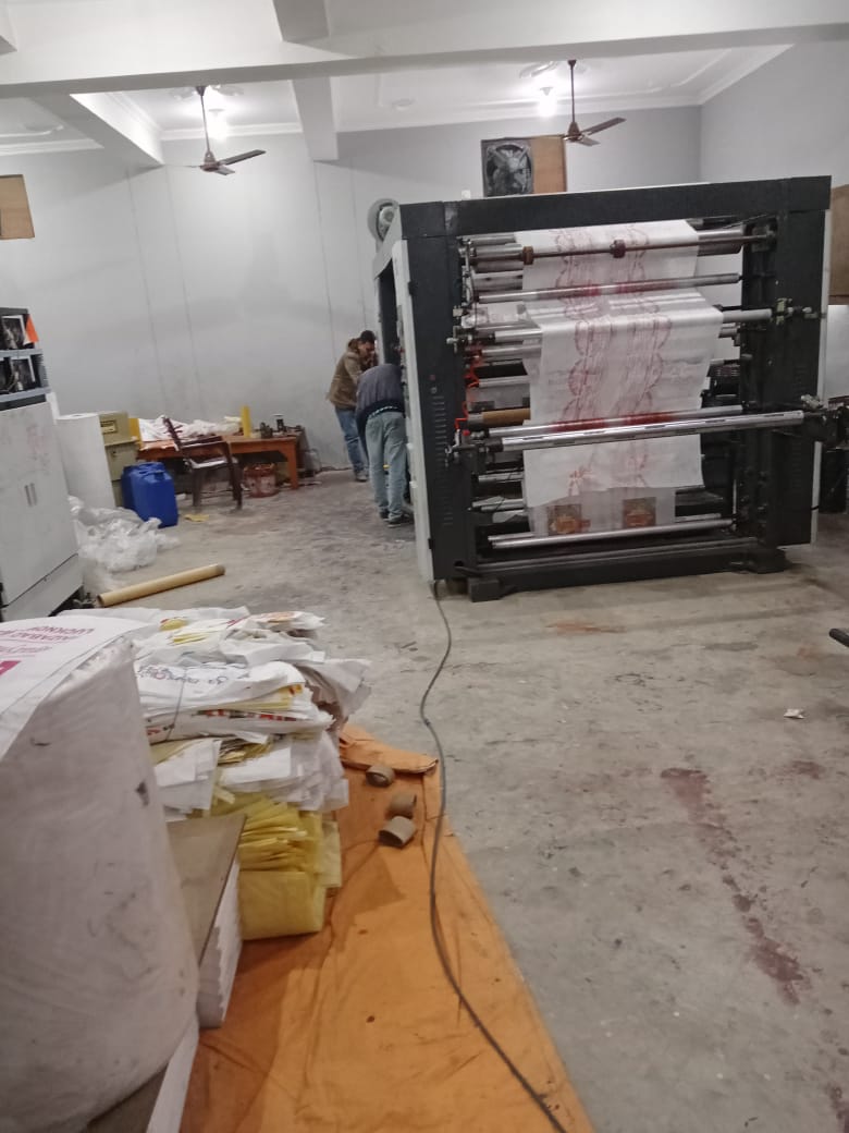 Two men working on a machine that makes cloth bags in India