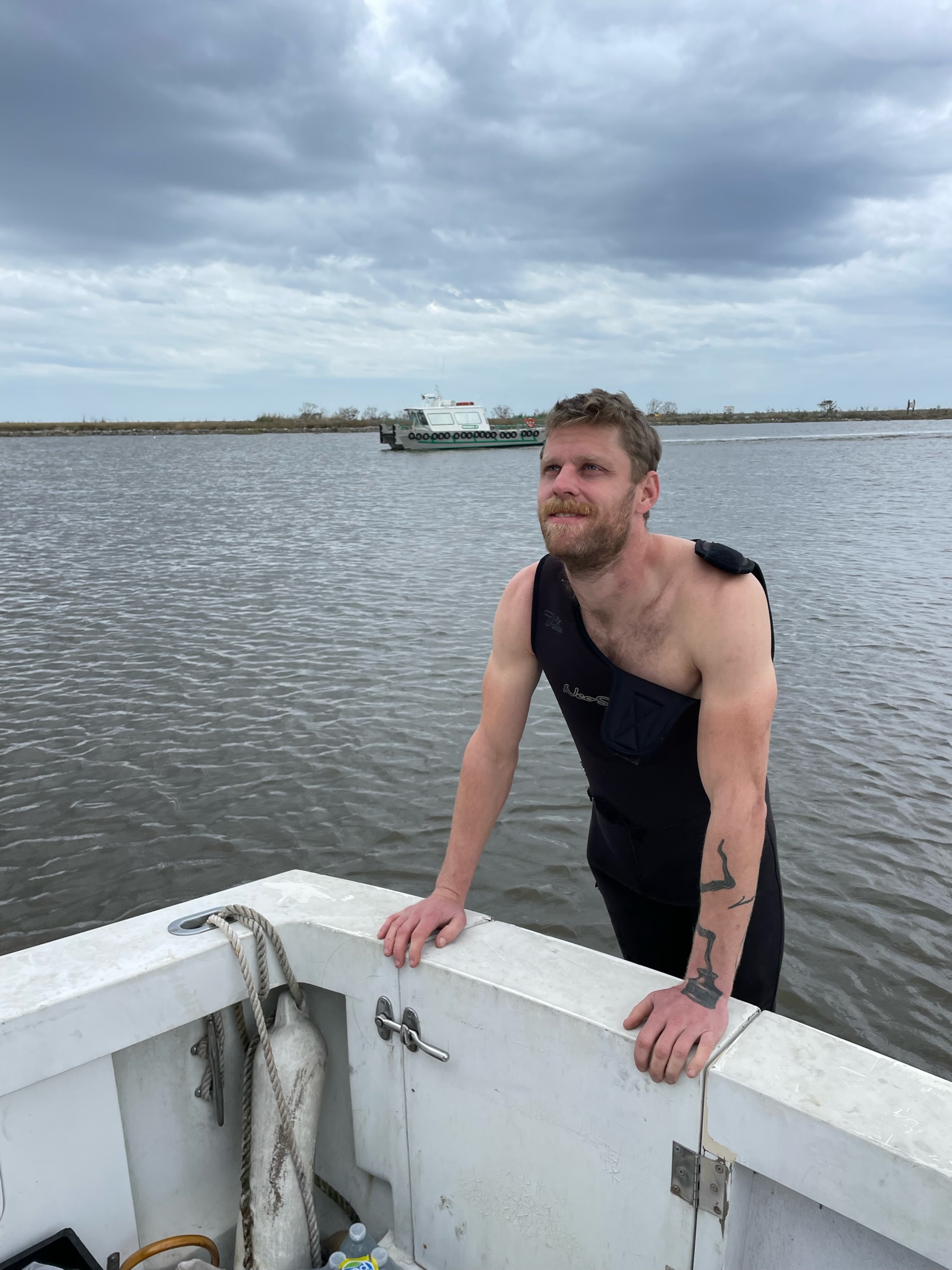 Lacava prepares to jump into the bayou to check for damage to the propellor.