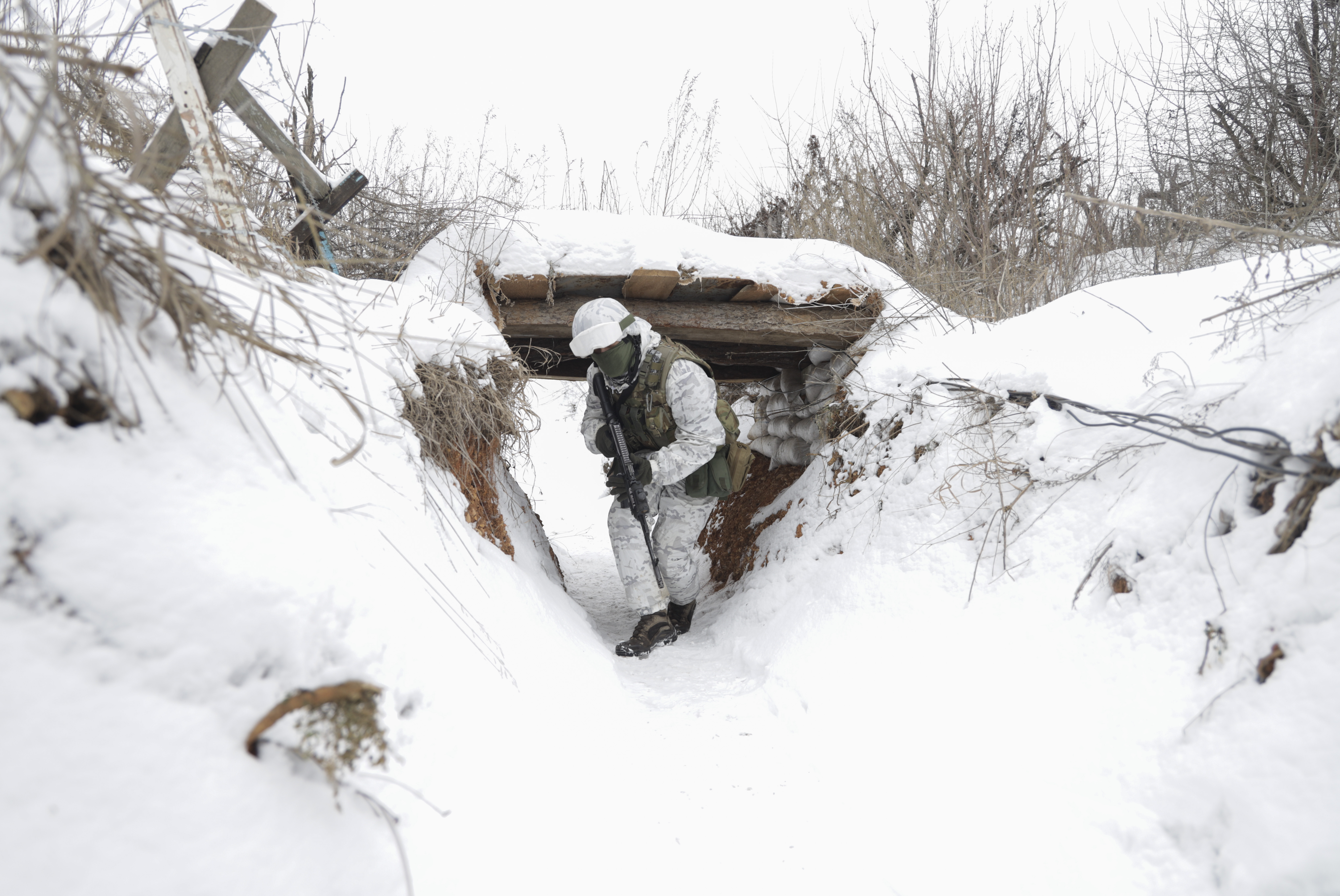 Ukrainian servicemen check the situation at the positions on a front line near the Avdiivka village