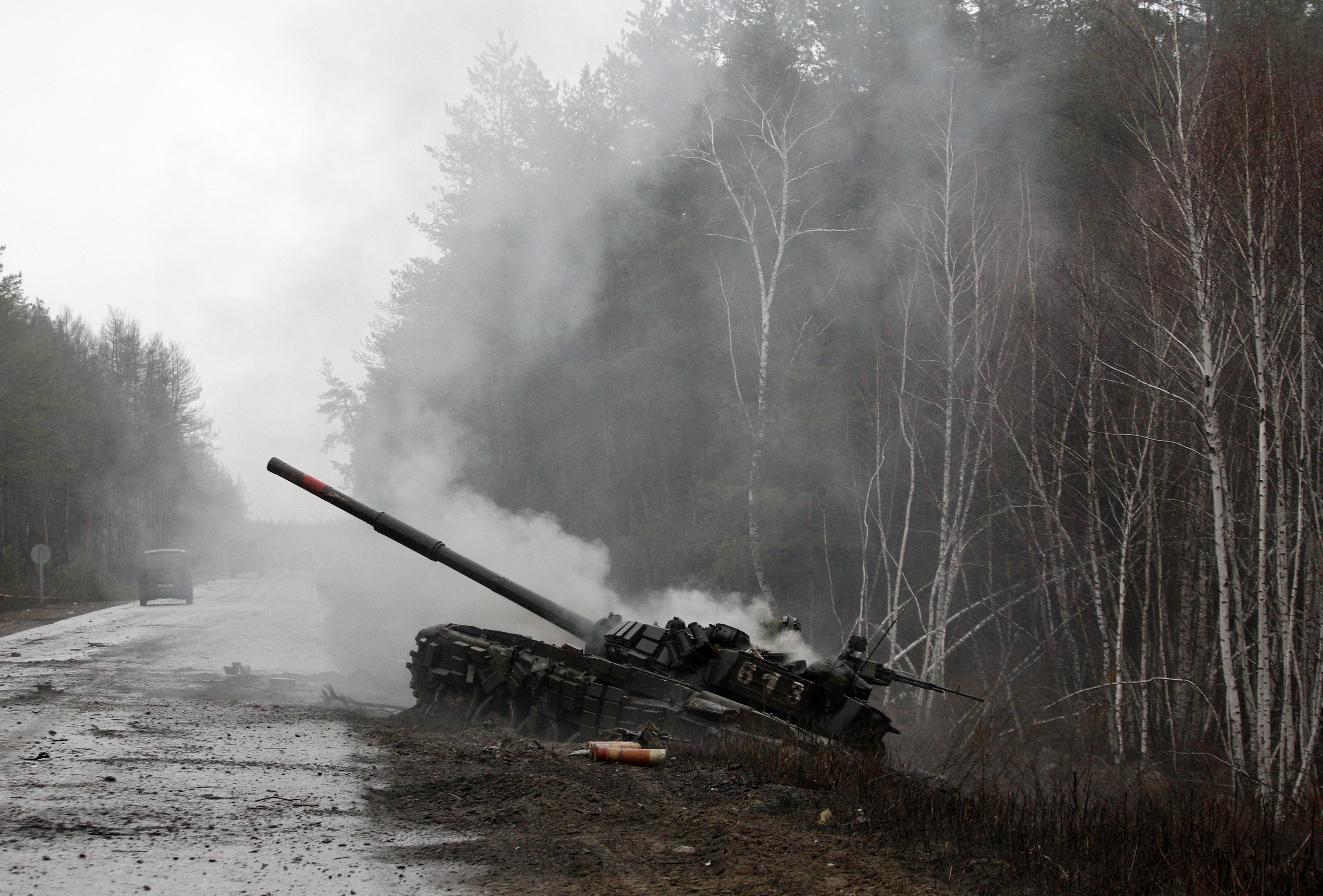 Smoke rises from a Russian tank destroyed in Ukraine