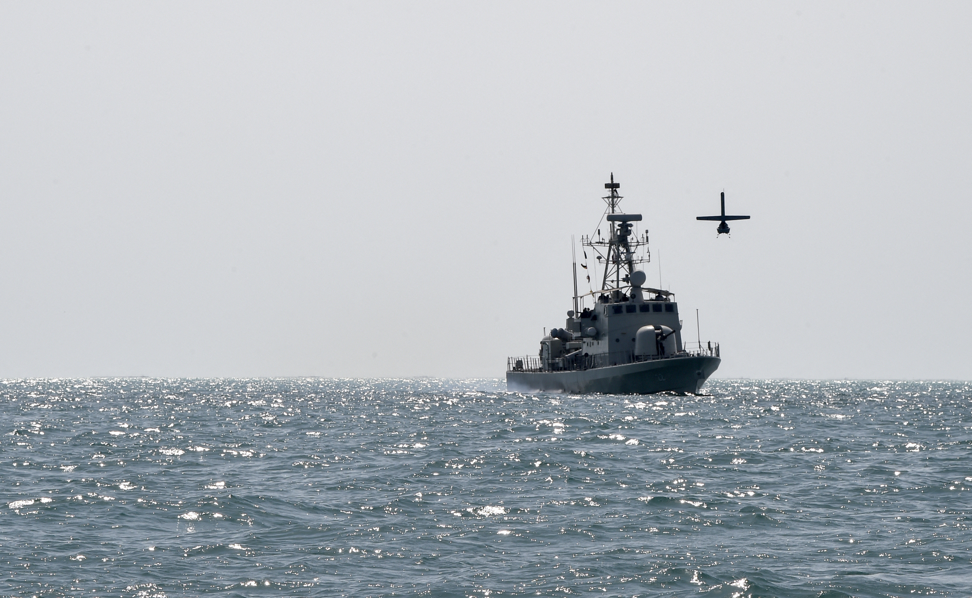 A US Navy Martin UAV drone flies over the Gulf waters as Royal Bahrain Naval Force (RBNF) Abdulrahman Al Fadhel takes part in joint naval exercise