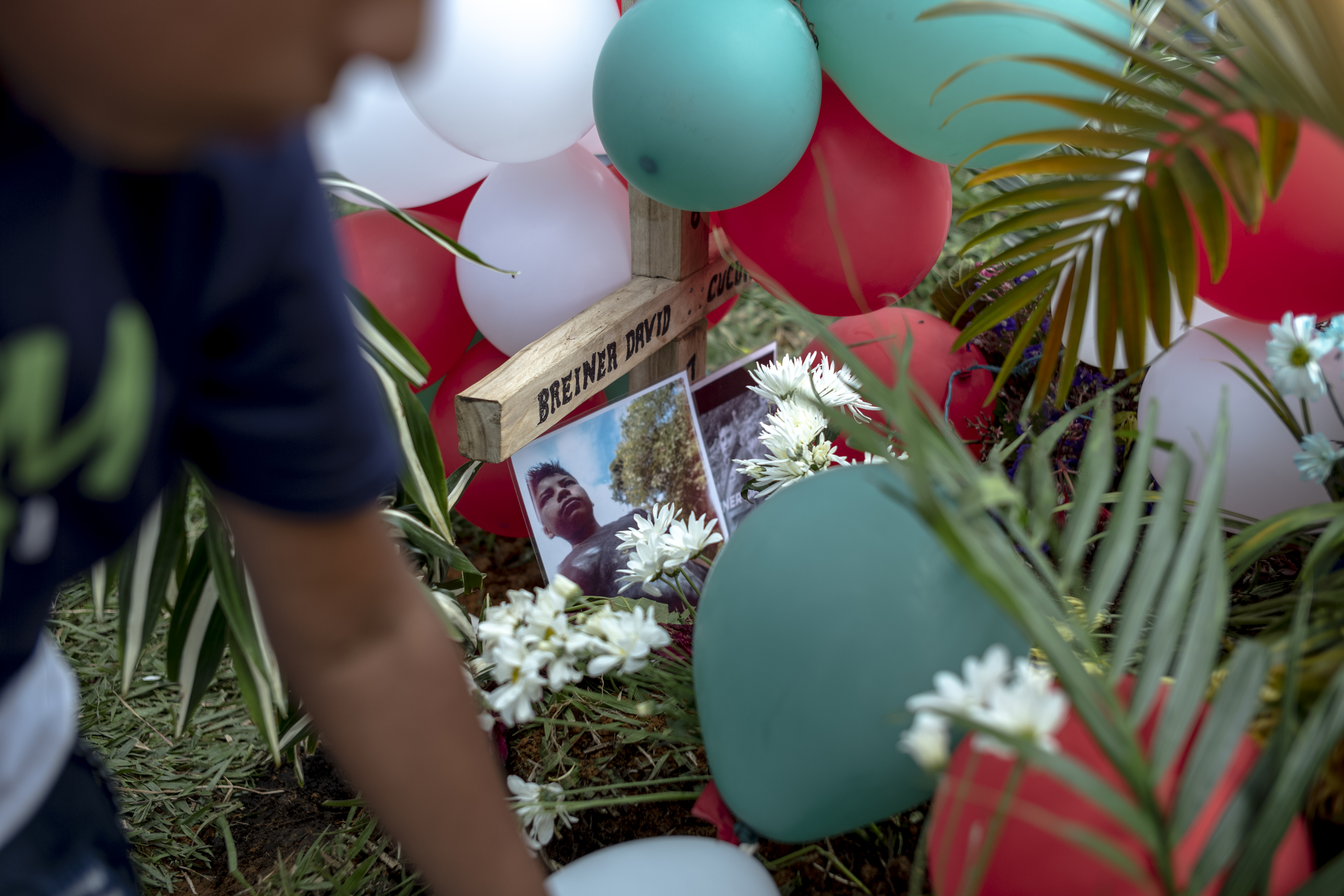 A photo of Breiner David was placed at the foot of the cross on his grave.