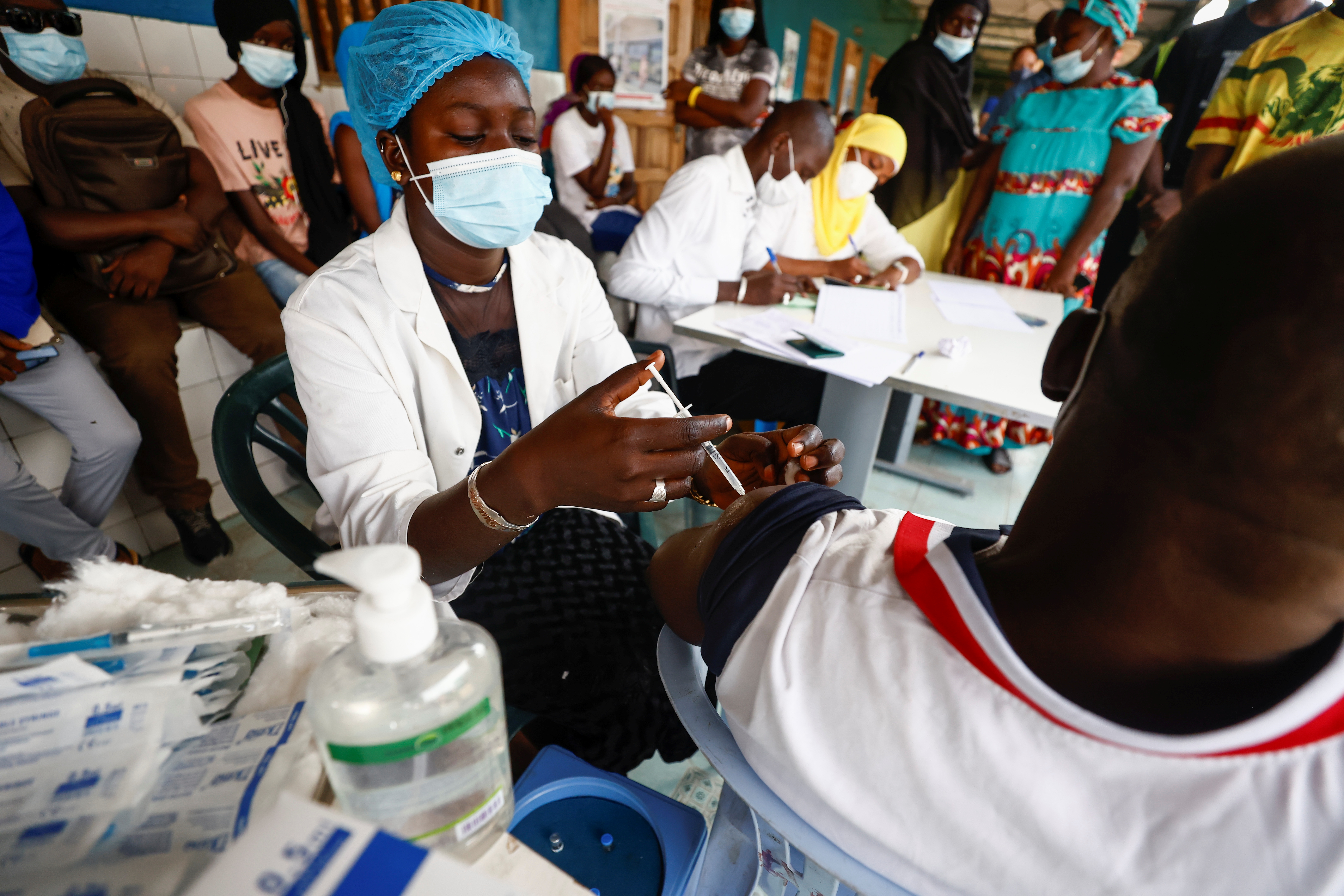 Aminata Laye Diagne, a nurse gives a dose of coronavirus disease (COVID-19) vaccine to a man at Philippe Senghor Hospital in Dakar