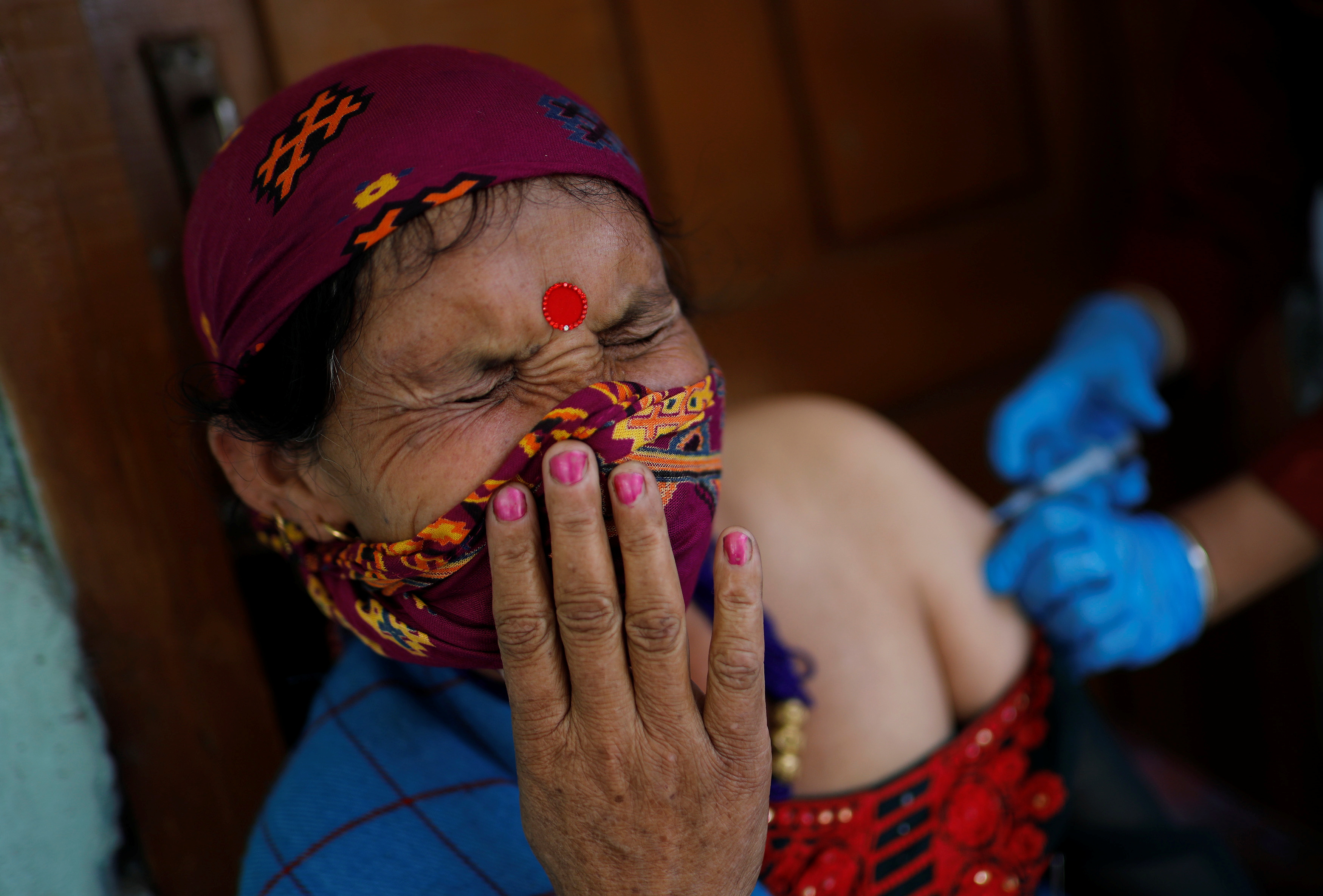 An Indian health worker gives a dose of the COVISHIELD vaccine as a part of a vaccination drive at Malana village in Kullu district in the Himalayan state of Himachal Pradesh, India, September 14, 2021.