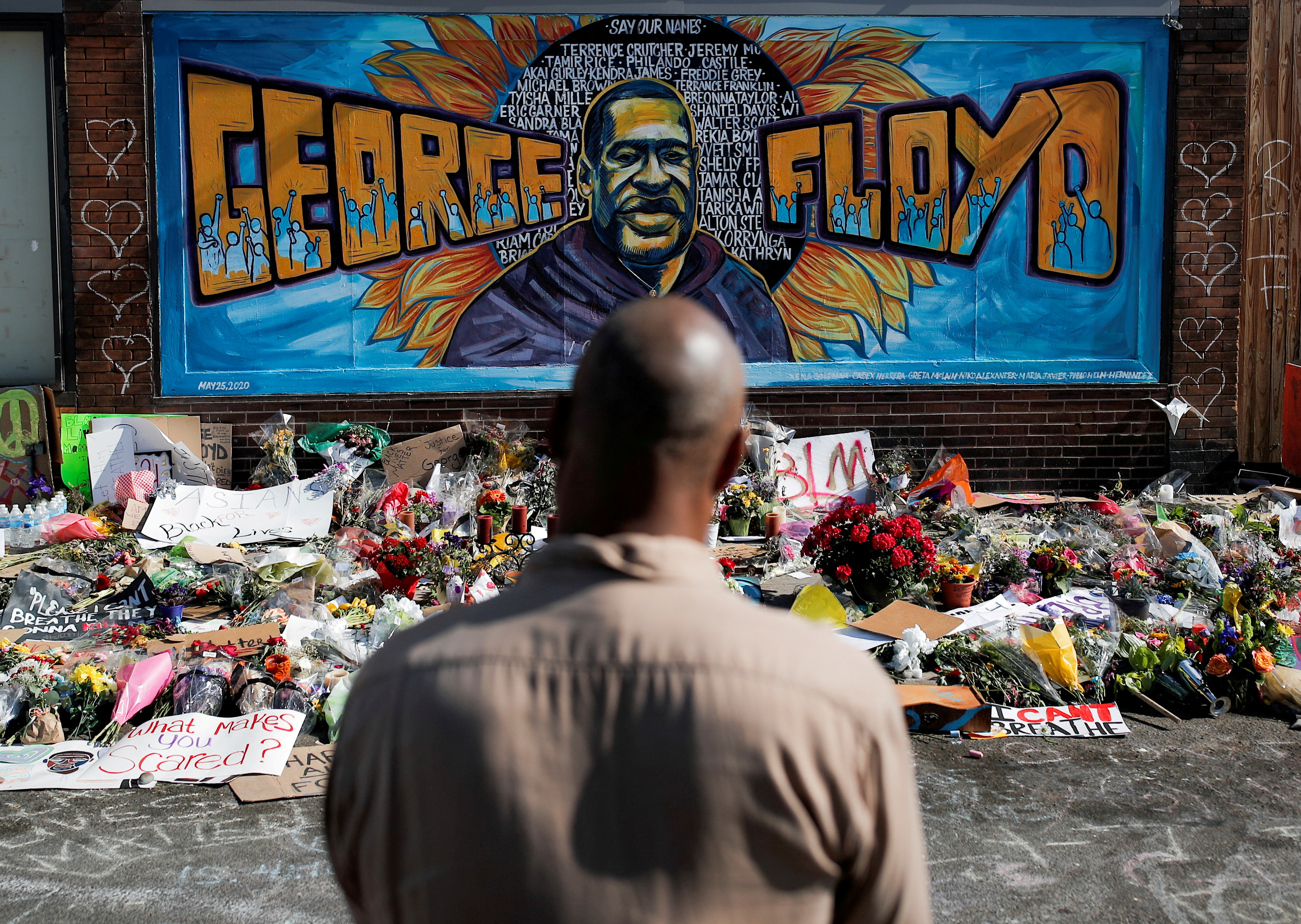 Man standing in front of memorial for George Floyd