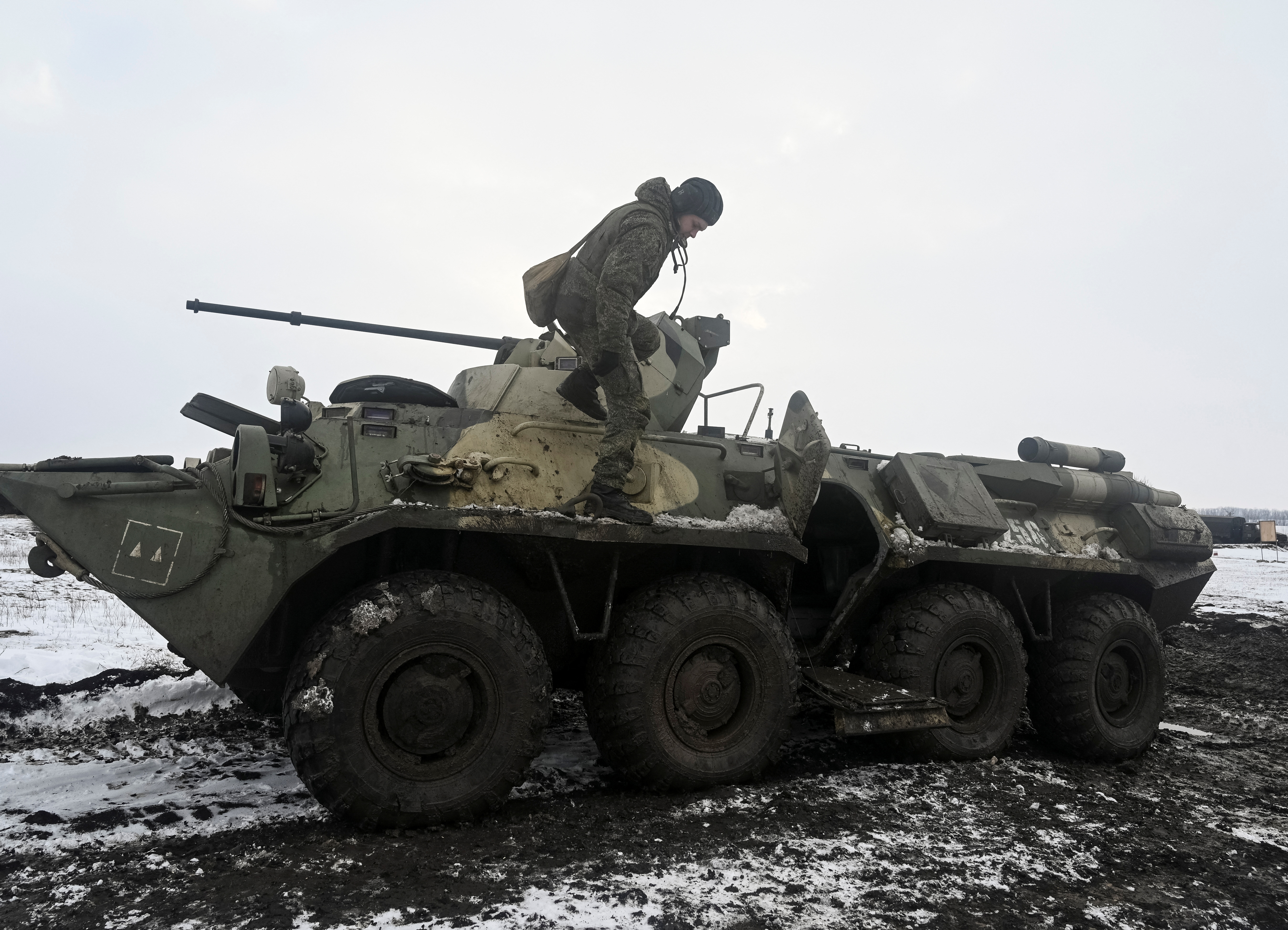 A Russian army service member is seen dismounting an armoured personnel carrier during drills at the Kuzminsky range in the southern Rostov region, Russia