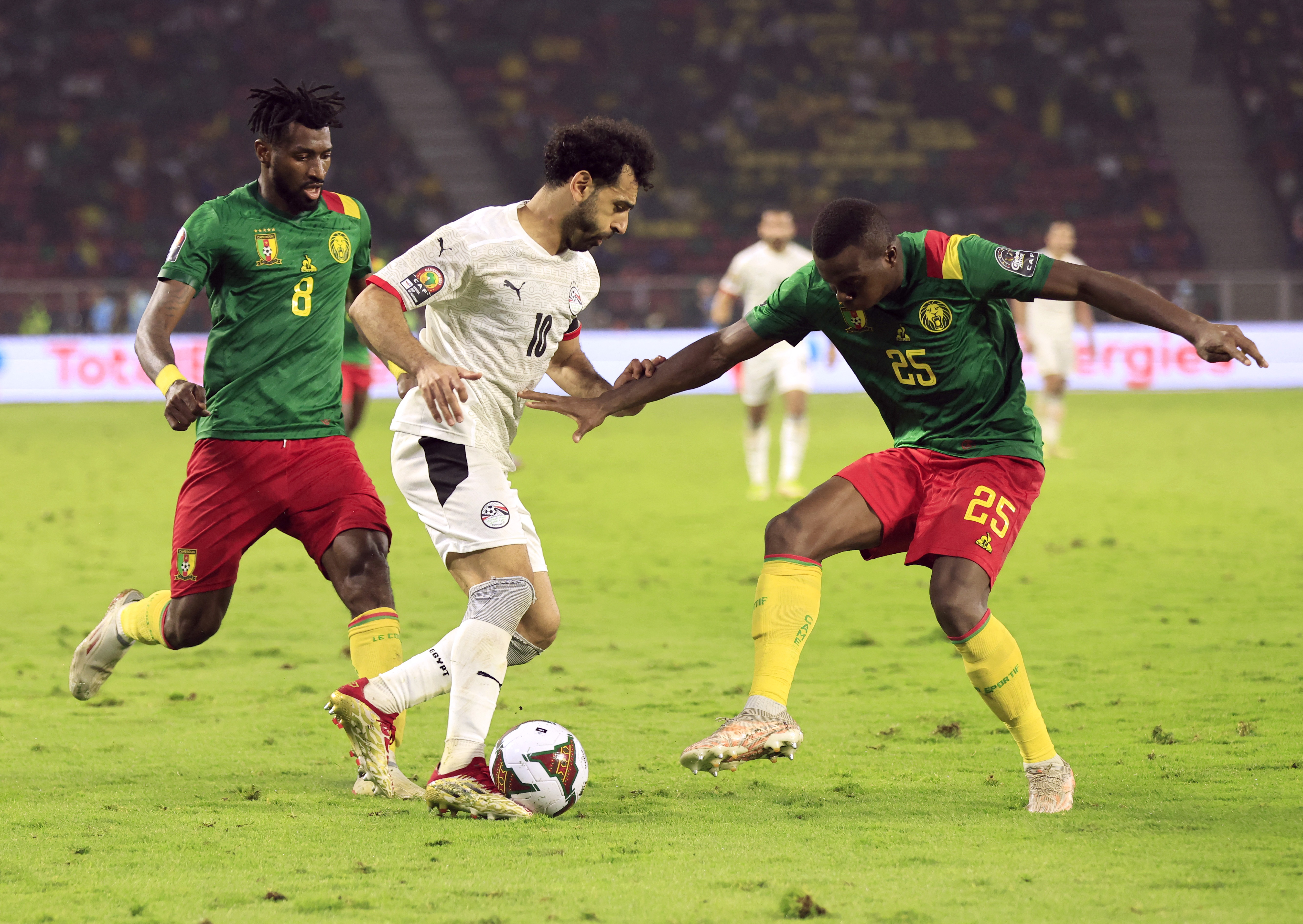 Egypt's Mohamed Salah in action with Cameroon's Andre-Frank Zambo Anguissa and Nouhou Tolo