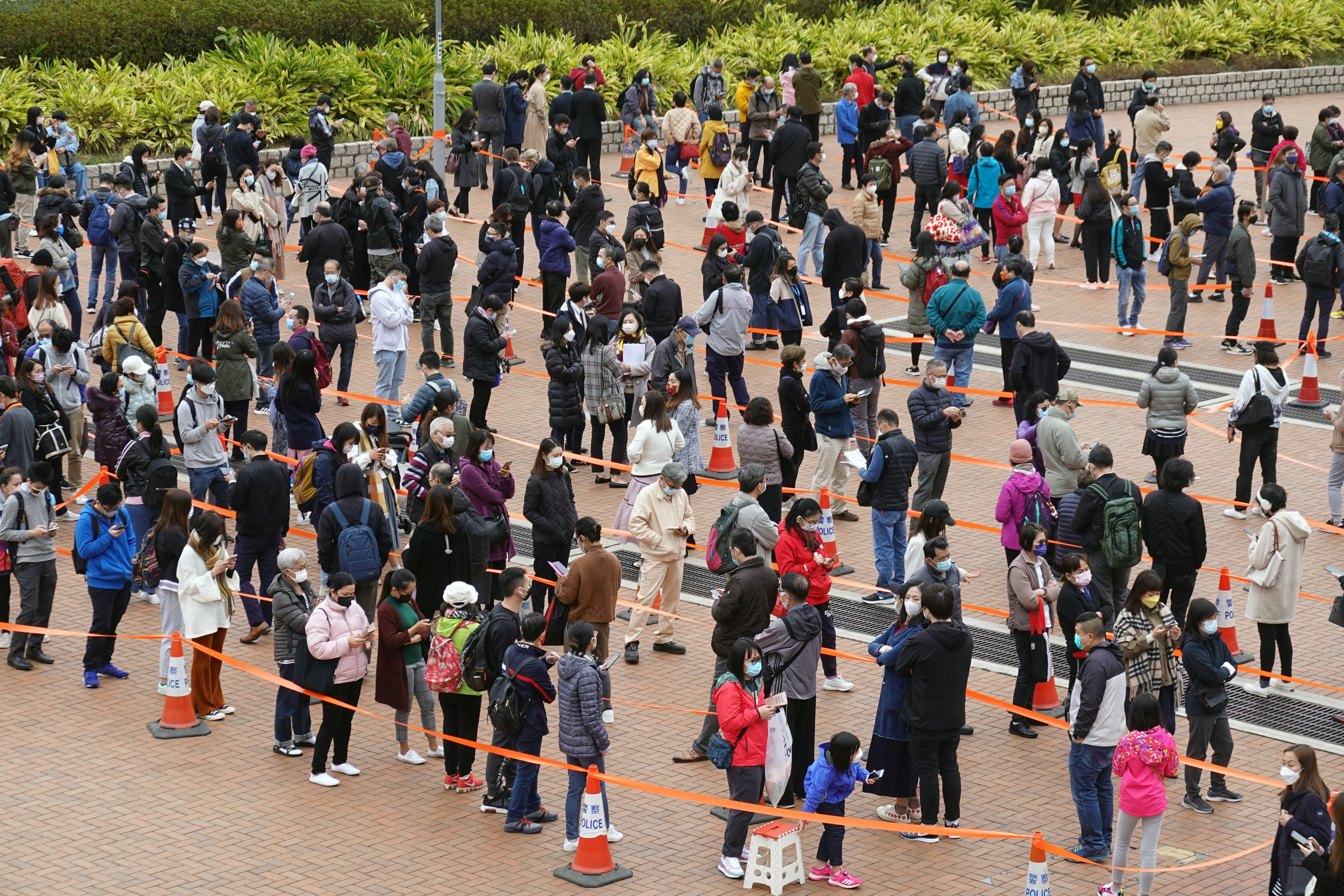 Queues of people waiting in a snaking line in Hong Kong to get COVID tests