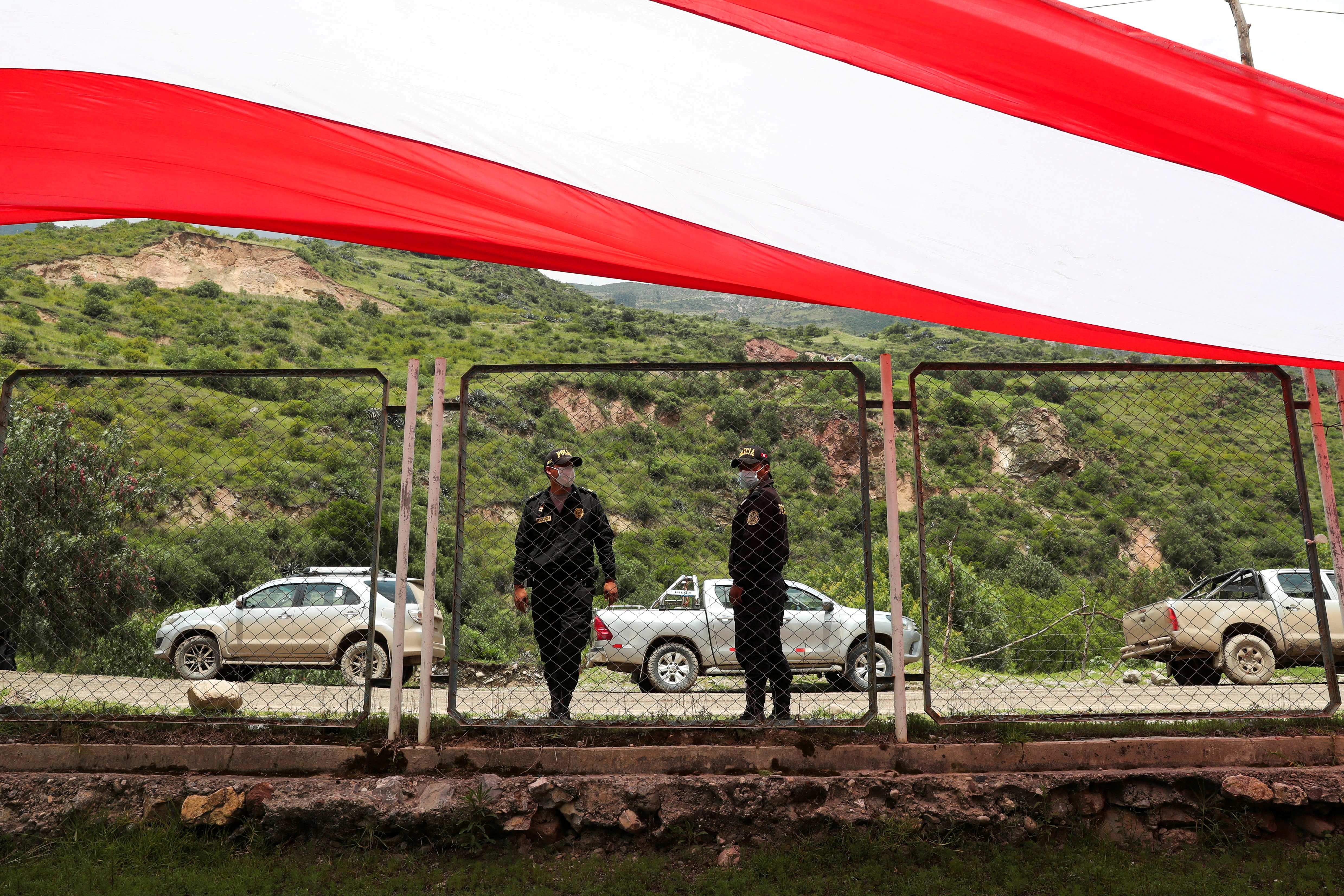 Police officers stand guard while people march as community leaders rejected a government proposal to prevent future blockades affecting the Las Bambas copper mine, in Sayhua, Peru January 17, 2022.