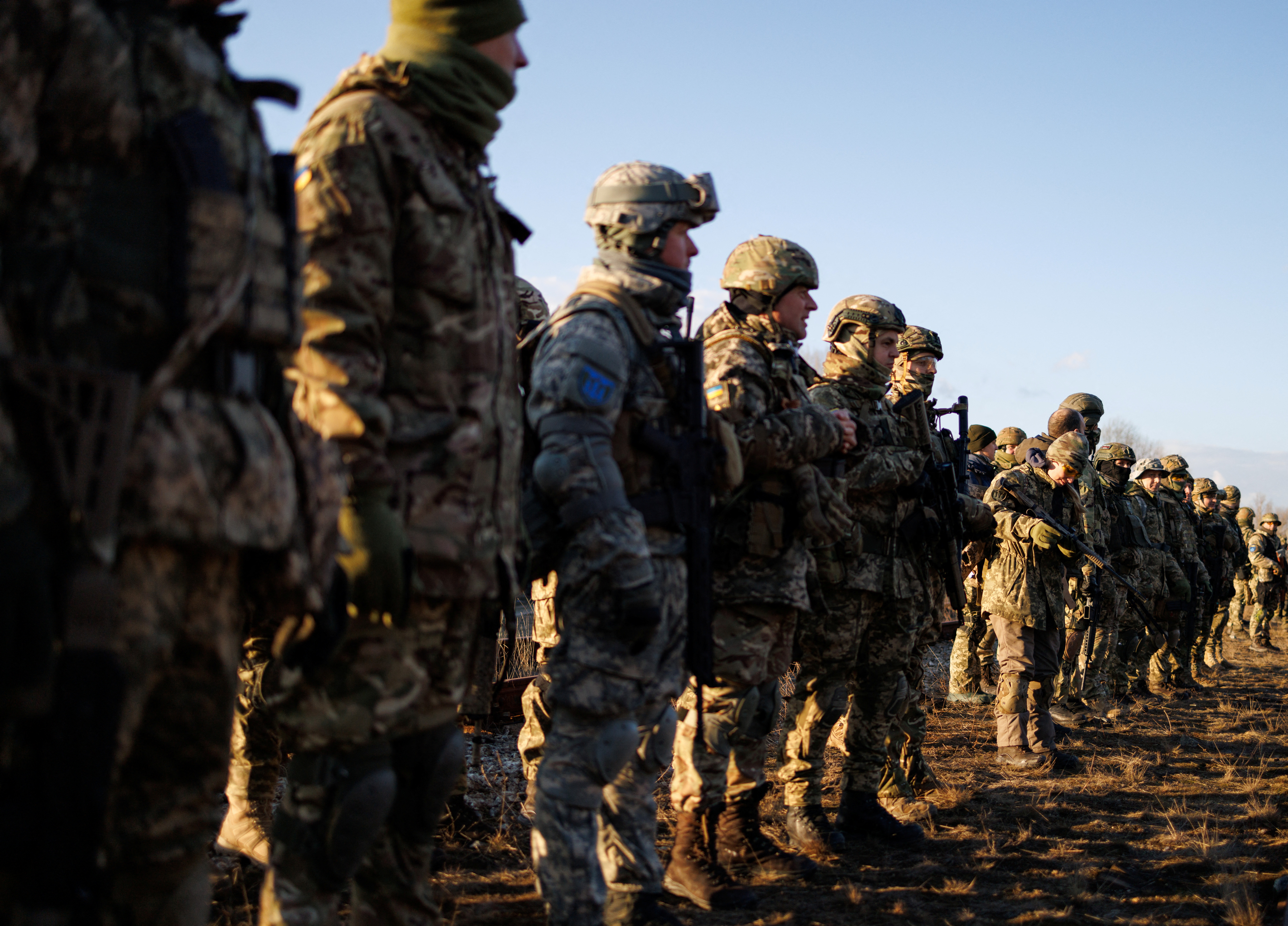 Ukraine's Territorial Defence Force stand in line after a combat skills training session