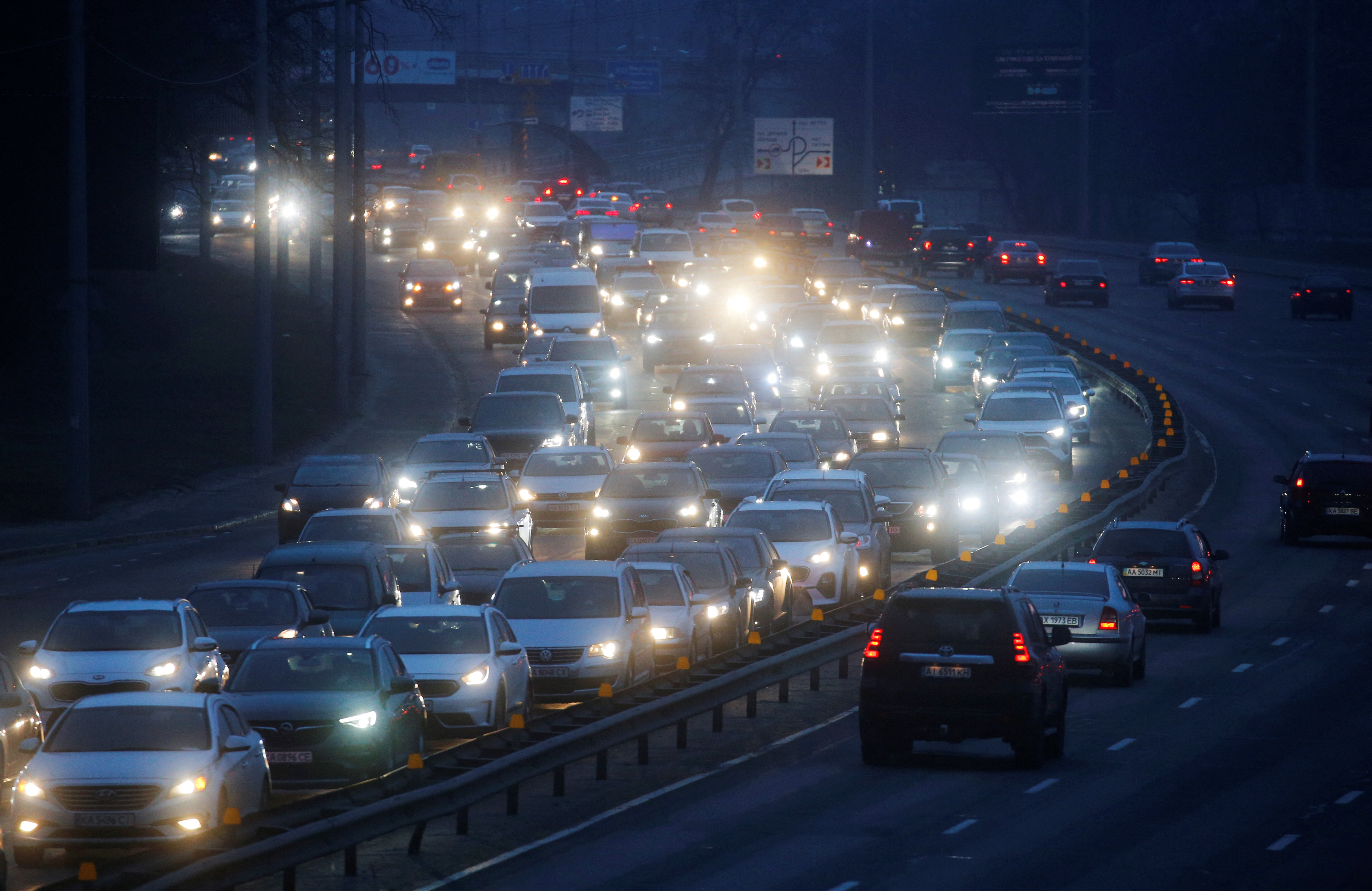 Cars drive towards the exit of the city after Russian President Vladimir Putin authorized a military operation in eastern Ukraine, in Kyiv