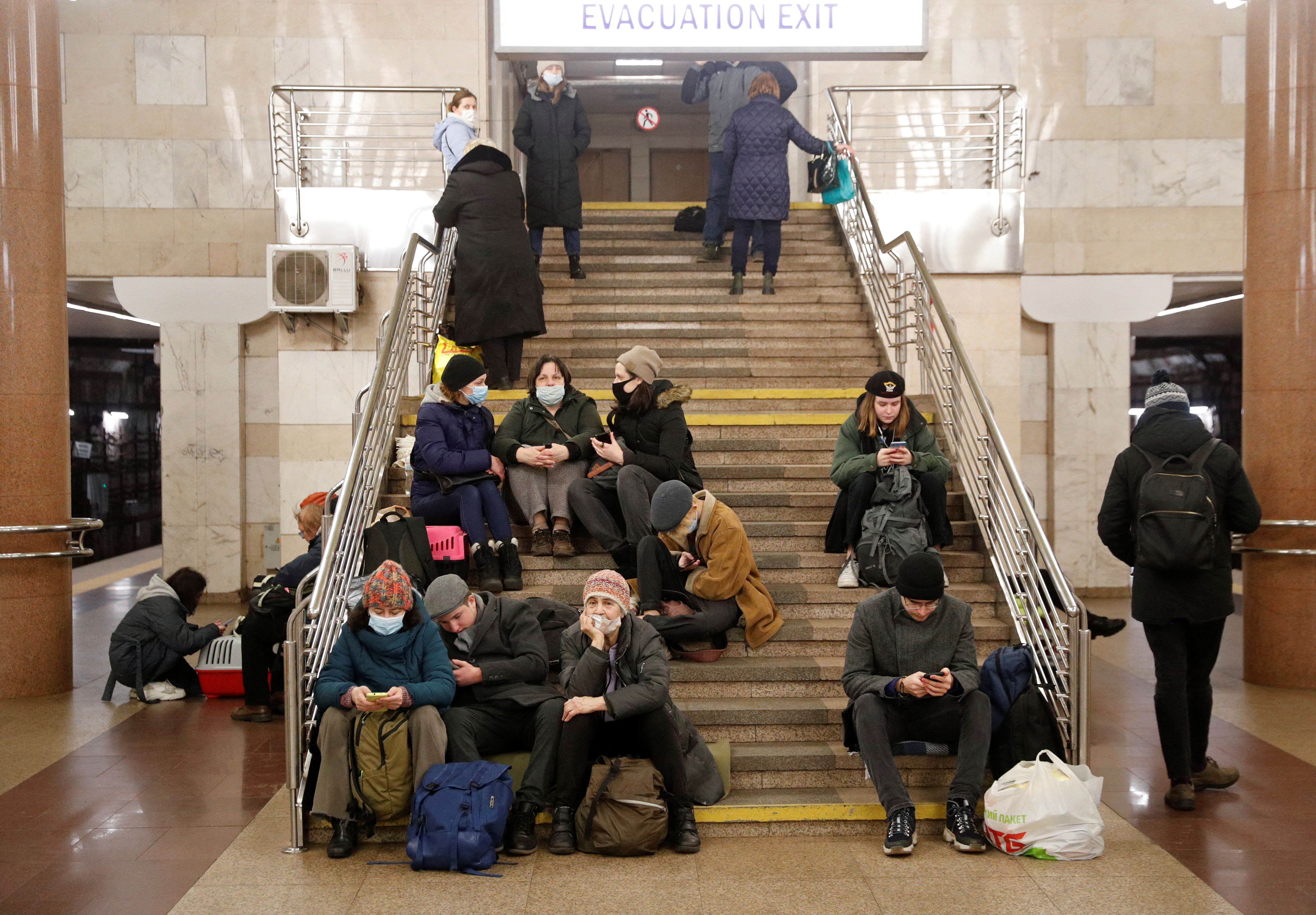People take shelter in a subway station, after Russian President Vladimir Putin authorized a military operation in eastern Ukraine, in Kyiv