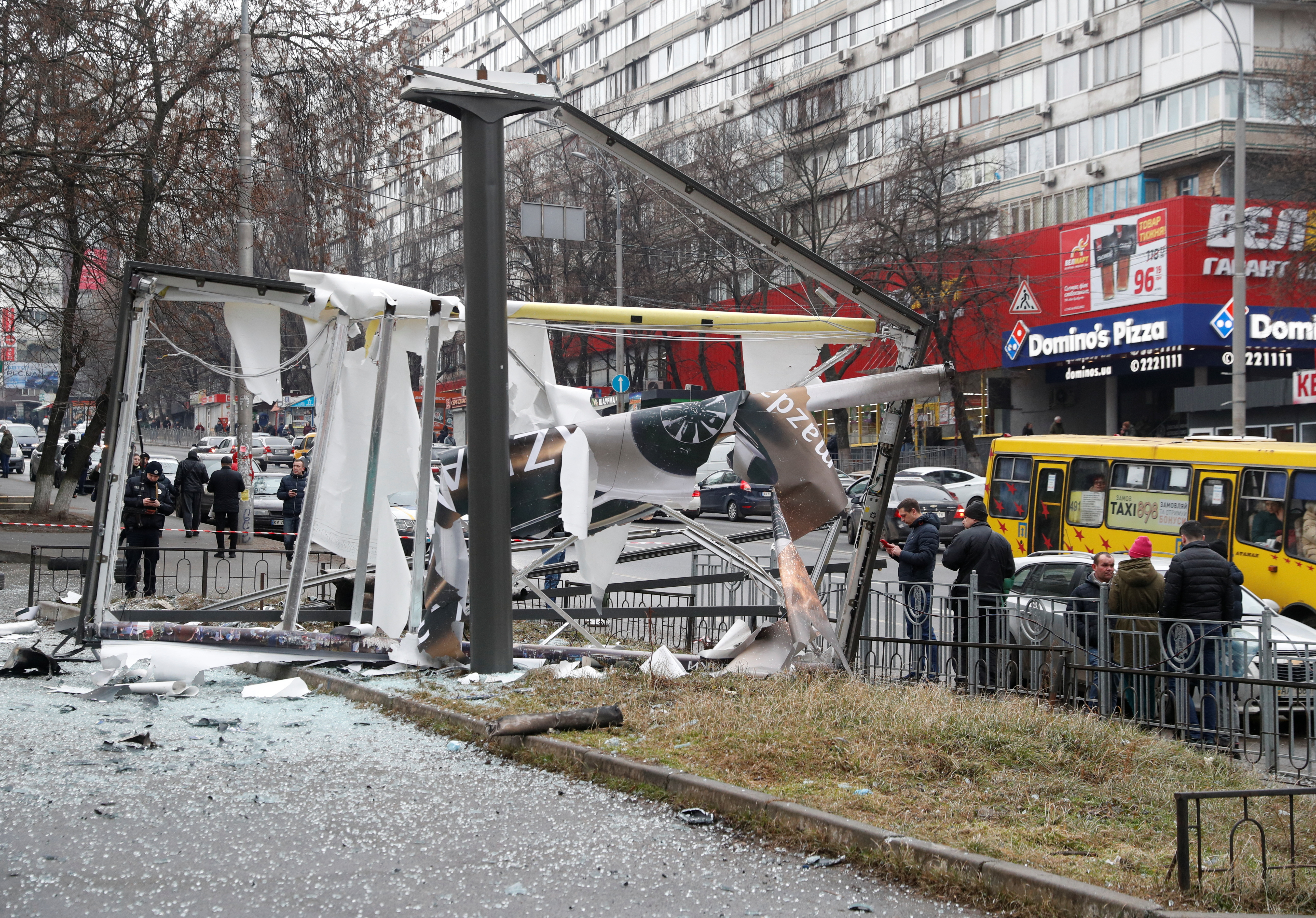 Debris and rubble are seen at the site where a missile landed in the street in Kyiv, Ukraine