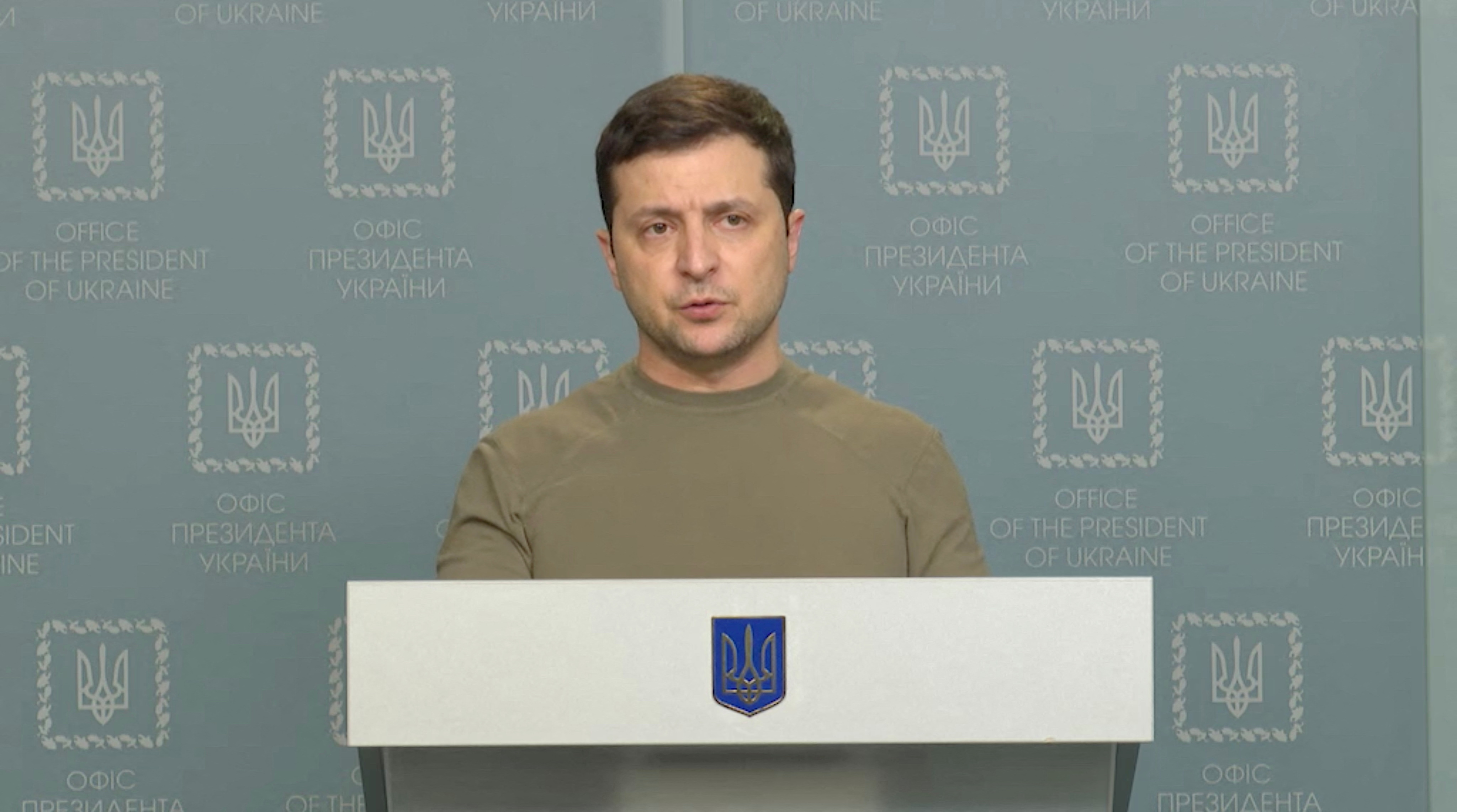 Ukrainian President Volodymyr Zelenskyy standing at a podium during a news briefing in Kyiv , Ukraine, February 24, 2022.