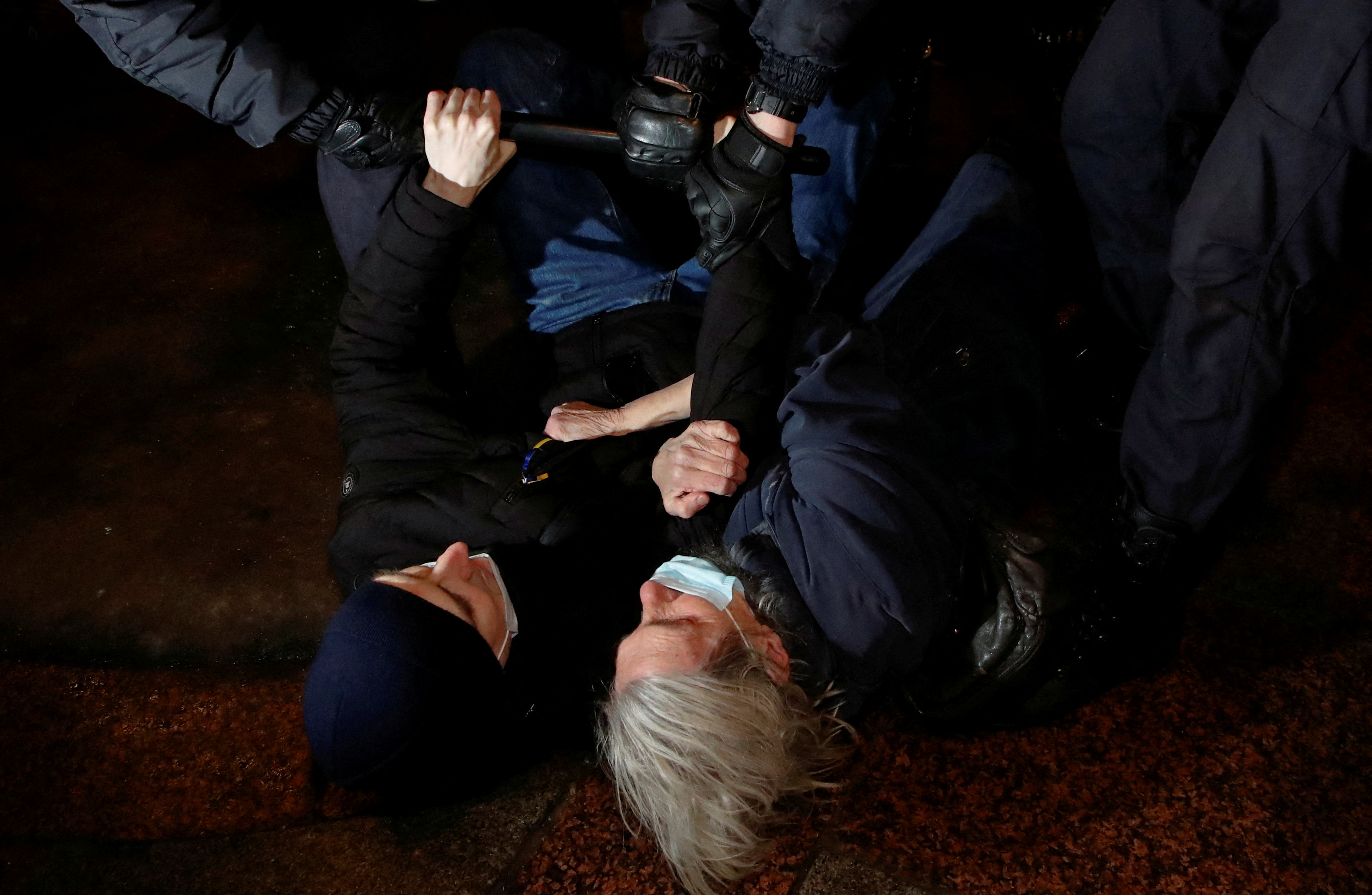 Police officers detain demonstrators during an anti-war protest, after Russian President Vladimir Putin authorized a military operation in eastern Ukraine, in Saint Petersburg, Russia, February 24, 2022. REUTERS/Anton Vaganov TPX IMAGES OF THE DAY
