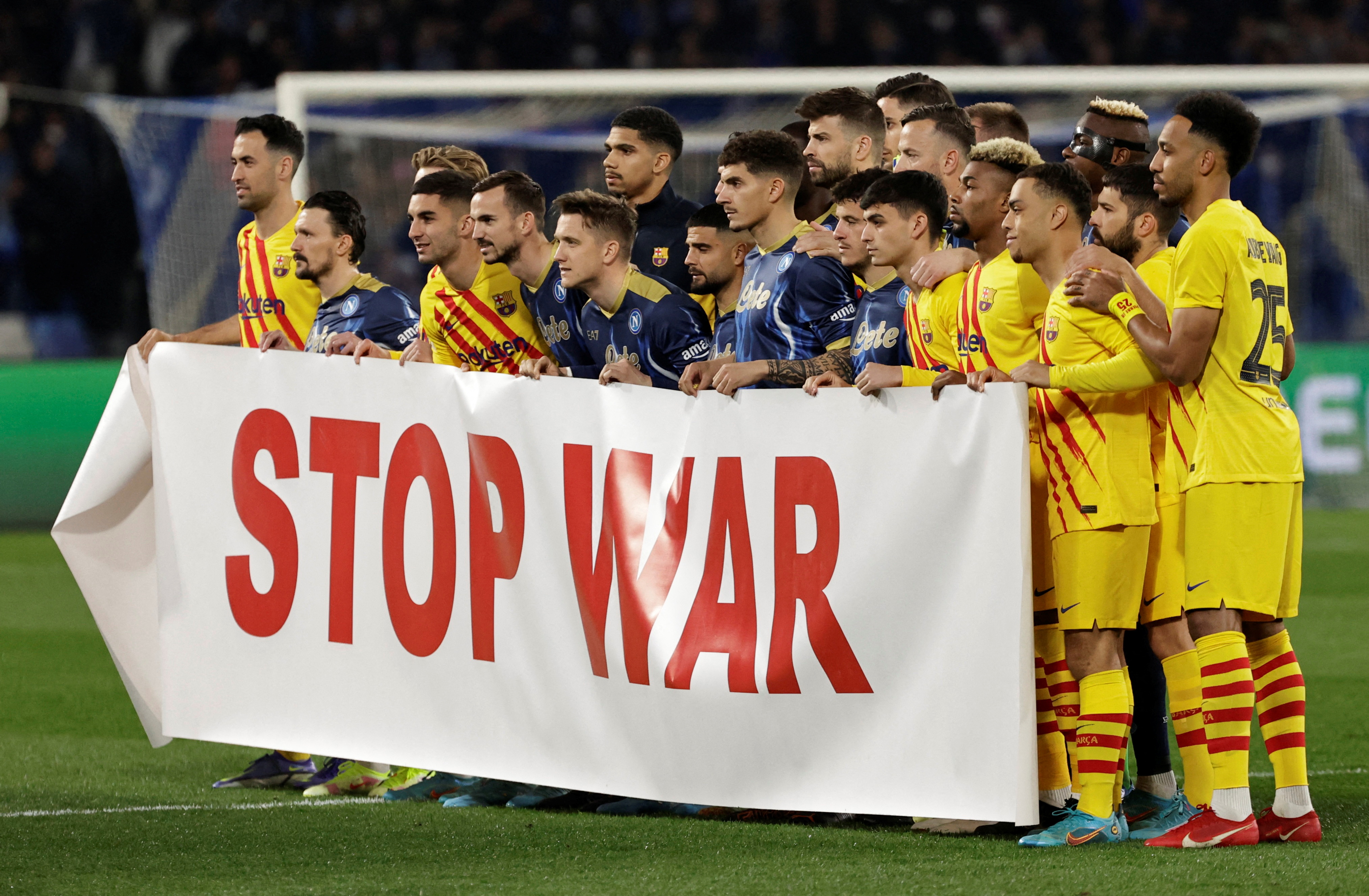 Napoli and Barcelona players display a 'Stop War' banner