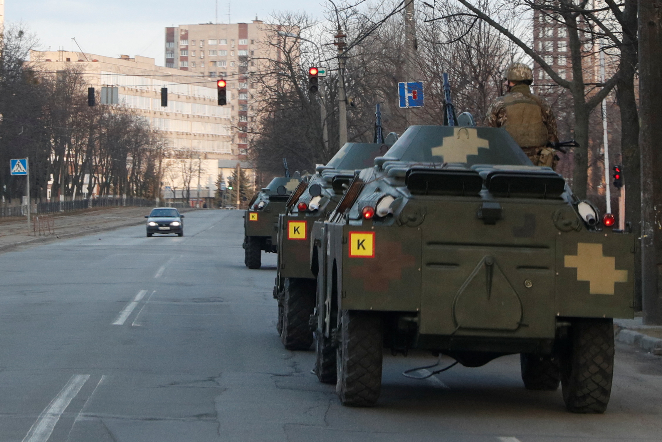 A Ukrainian service member is seen atop of an armoured personal carrier in Kyiv