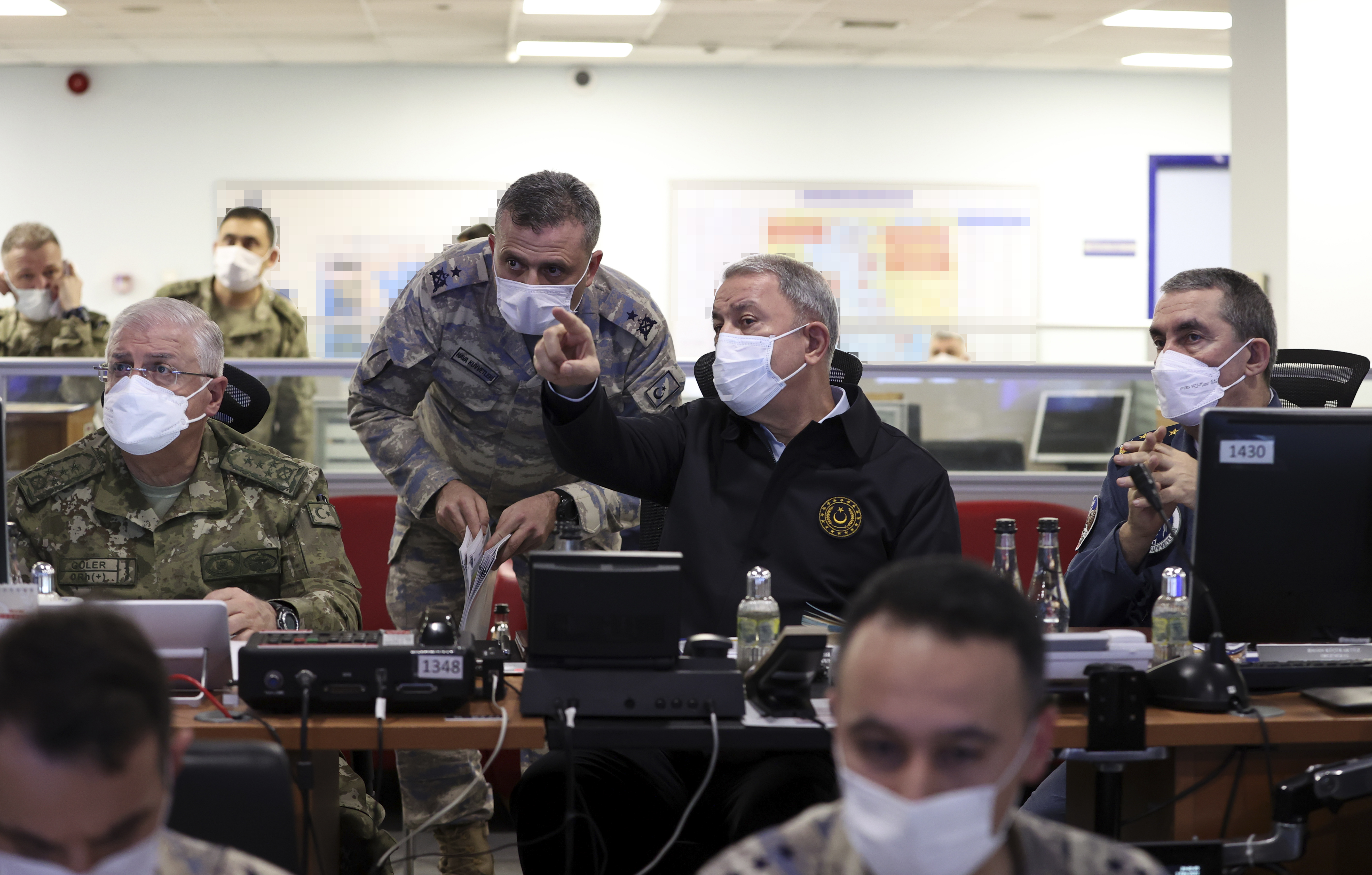 Turkish Defence Minister Hulusi Akar working along colleagues to conduct 'Operation Winter Eagle' in an air force command base in Ankara