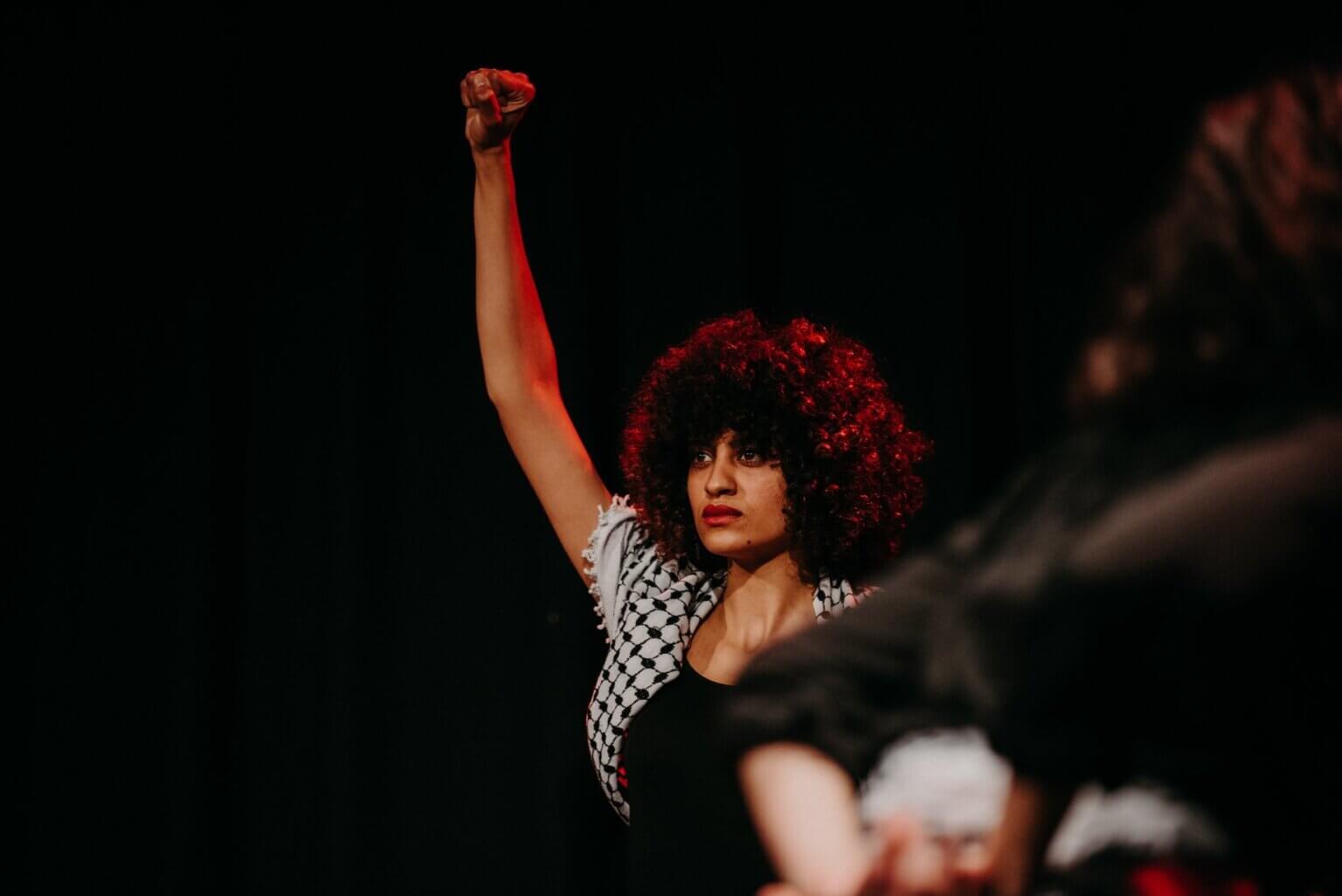 Palestinian activist Shahd Abusalama holding up her first