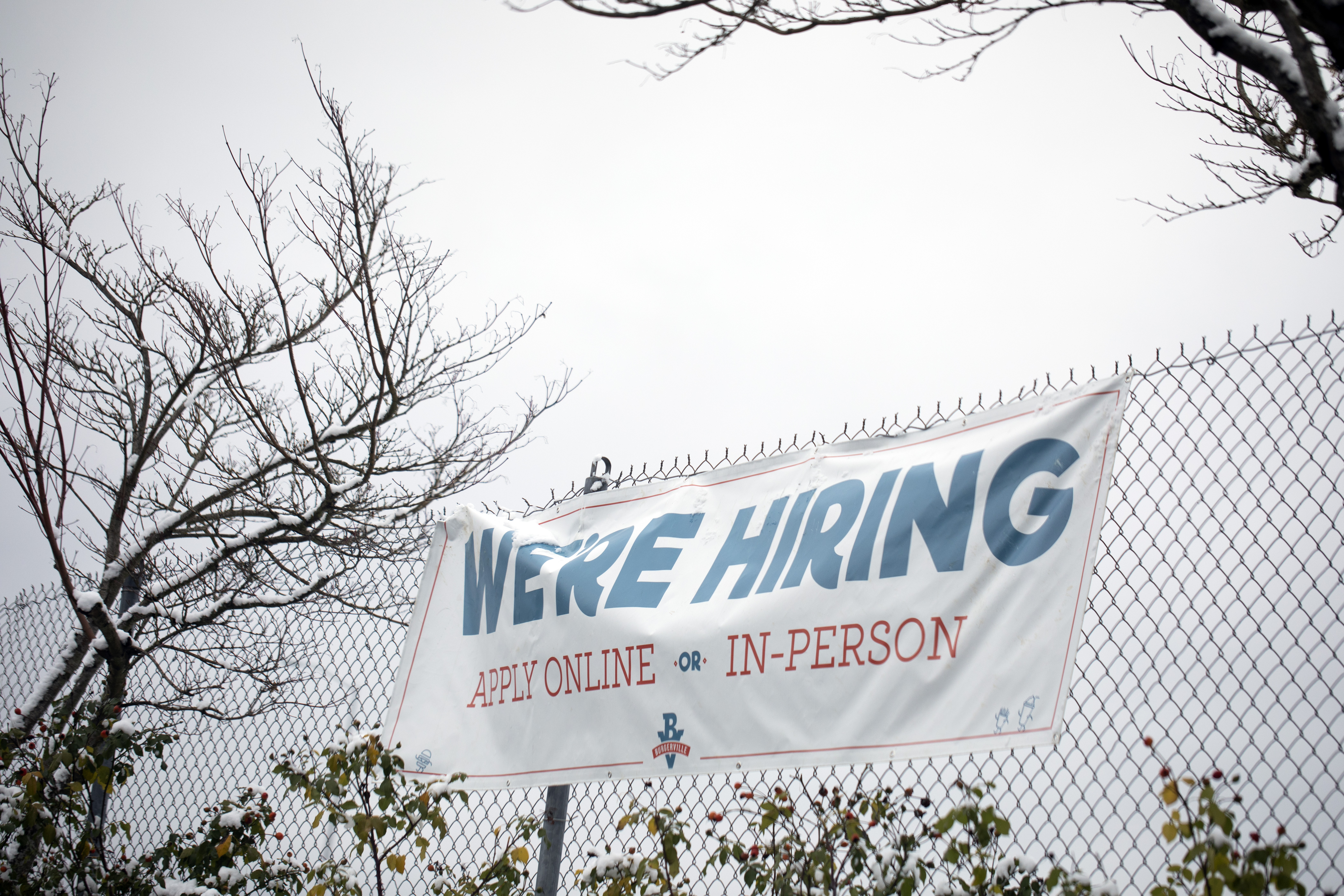 A sign seeking workers is displayed at a fast food restaurant in Portland, Oregon