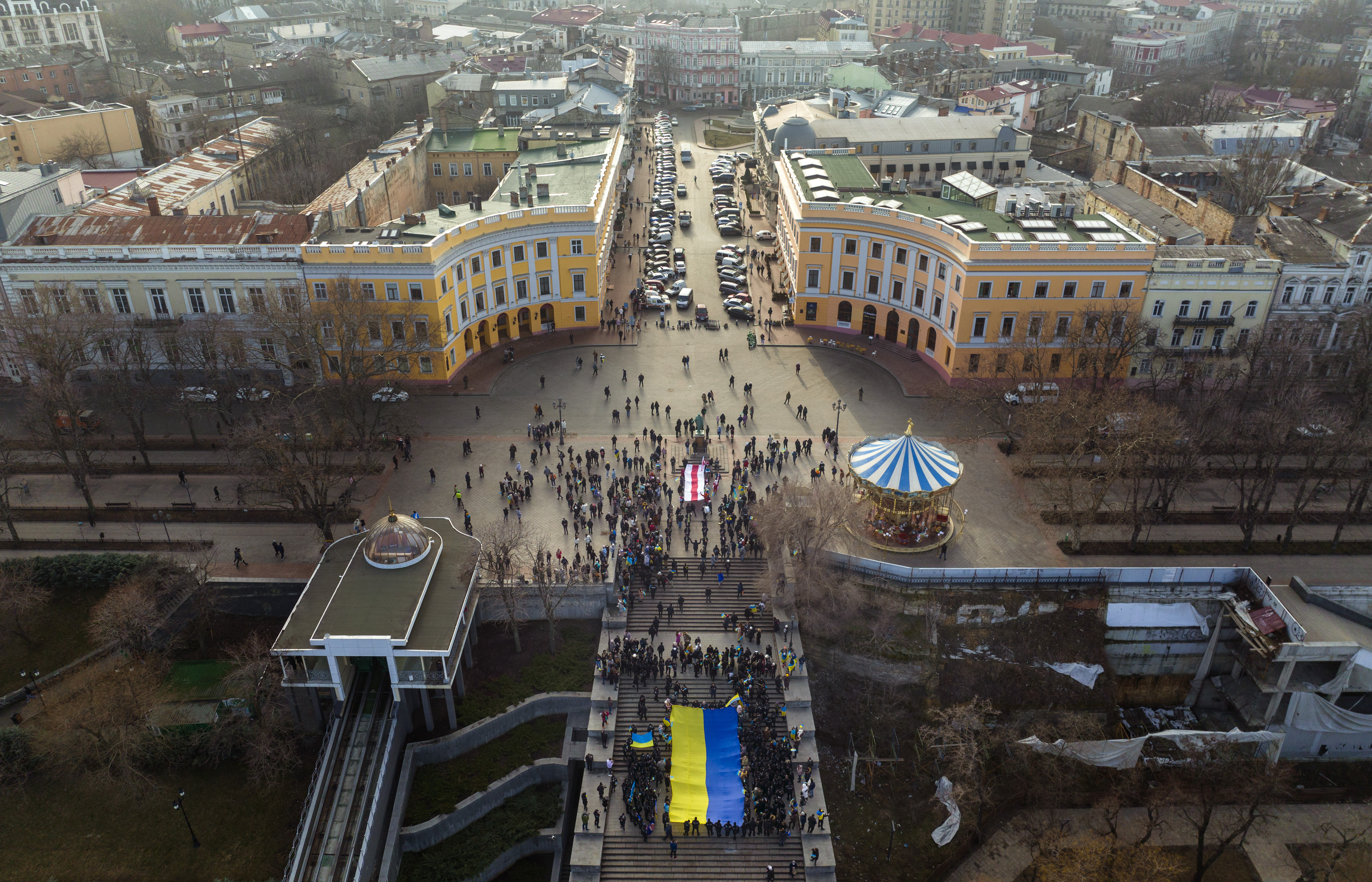 Ukrainians march holding a national flag to celebrate a Day of Unity in Odessa, Ukraine