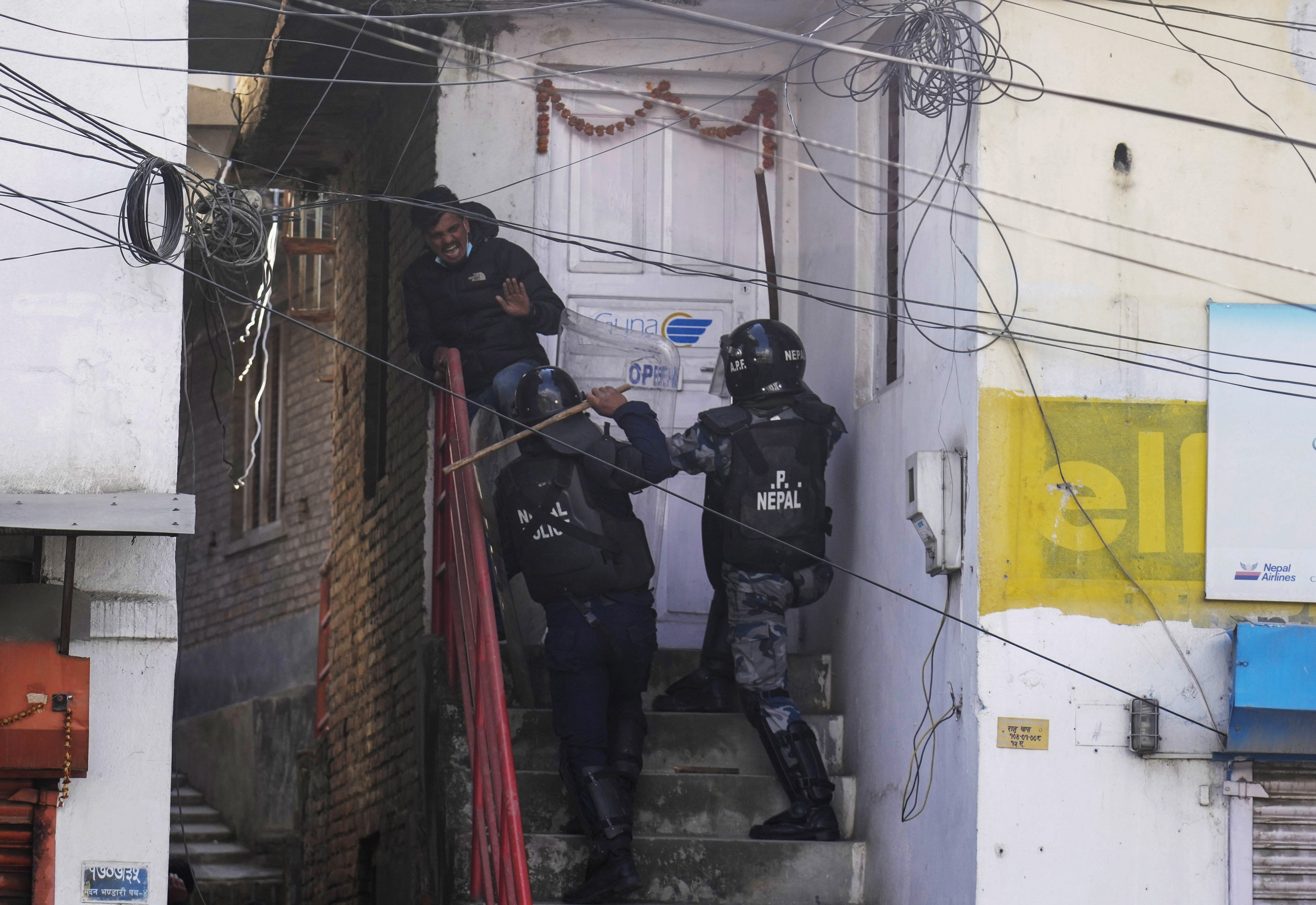 Nepalese police baton charge a protester