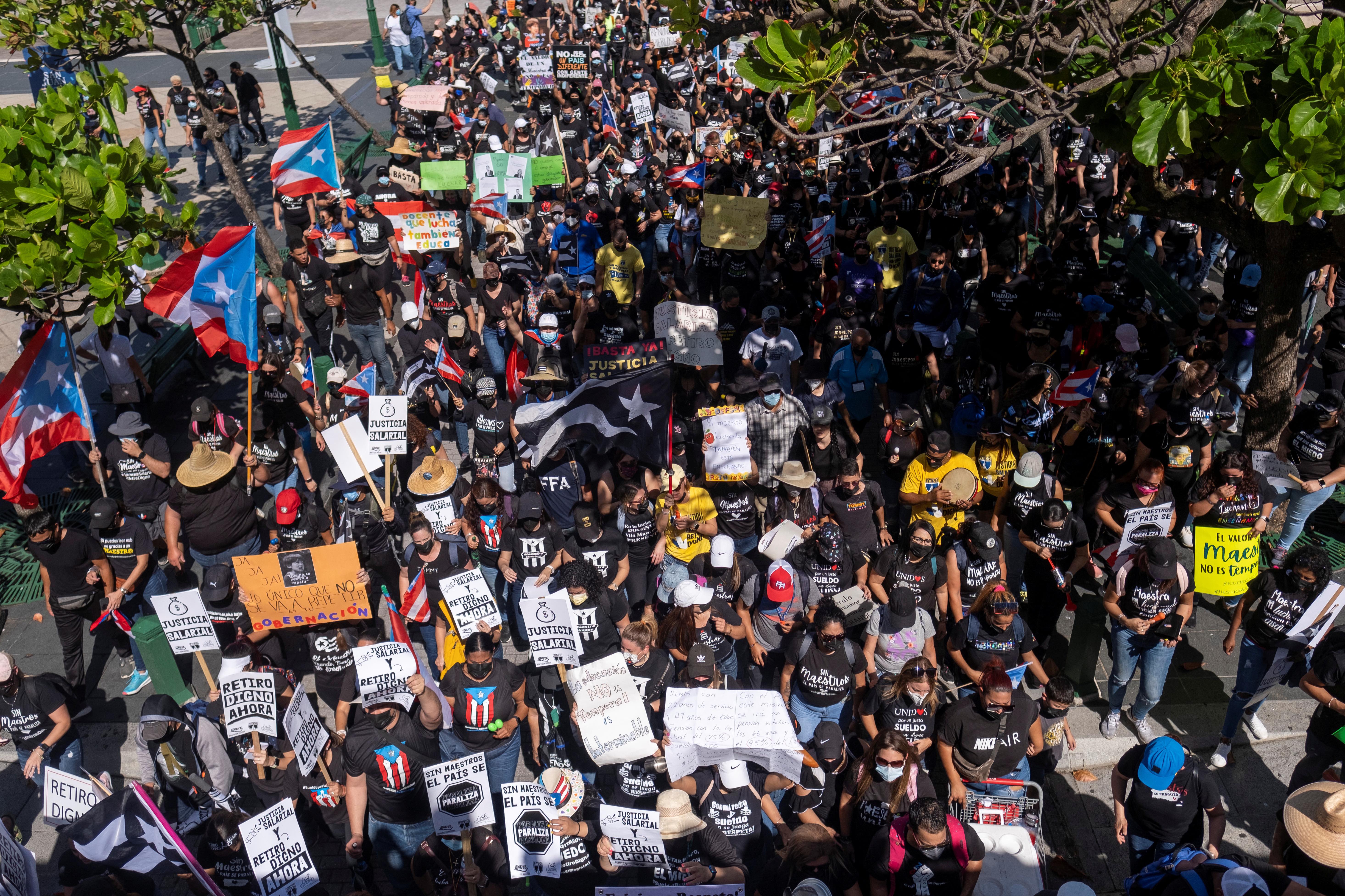 People march through the streets of Old San Juan