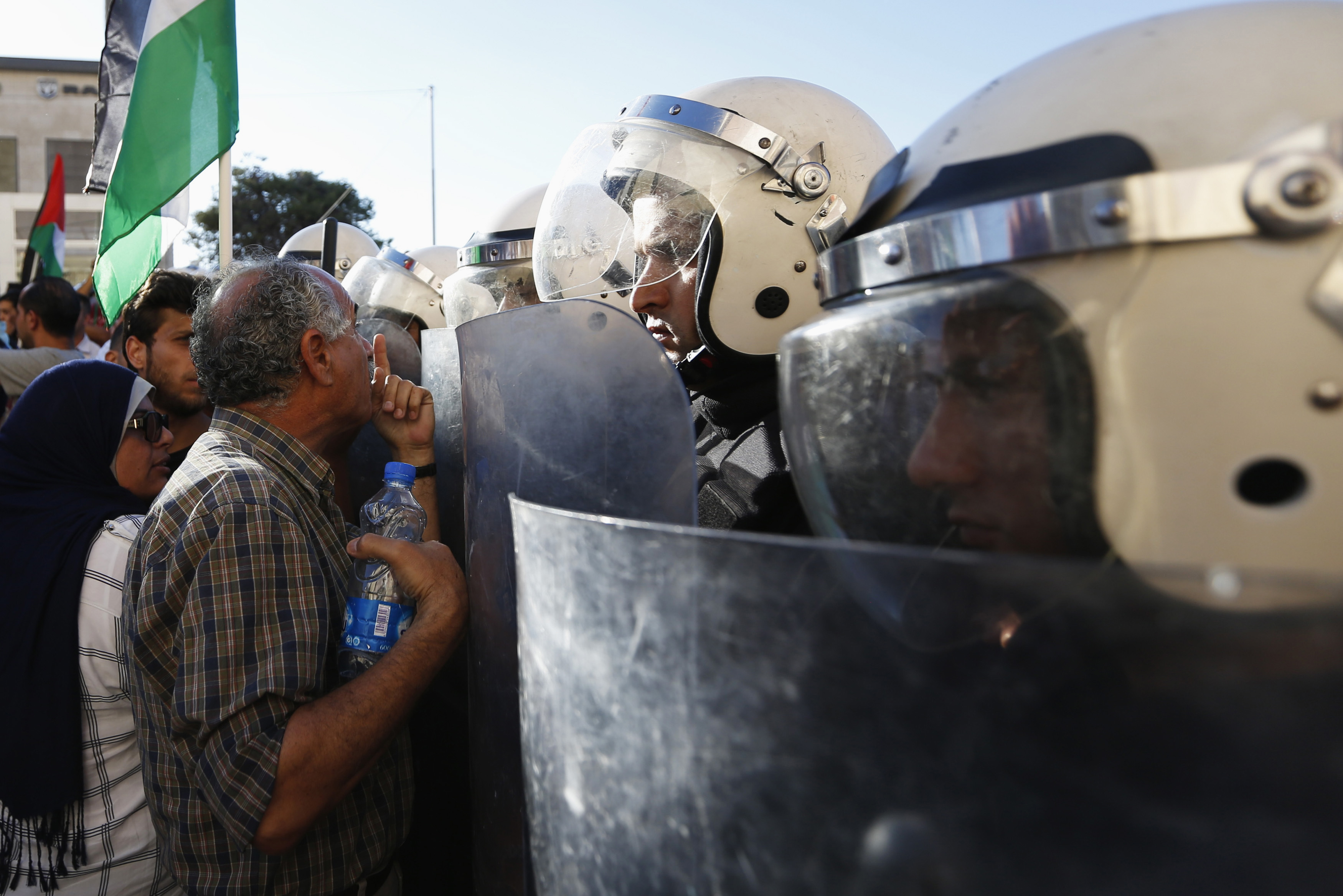 A Protester argues with Palestinian riot police