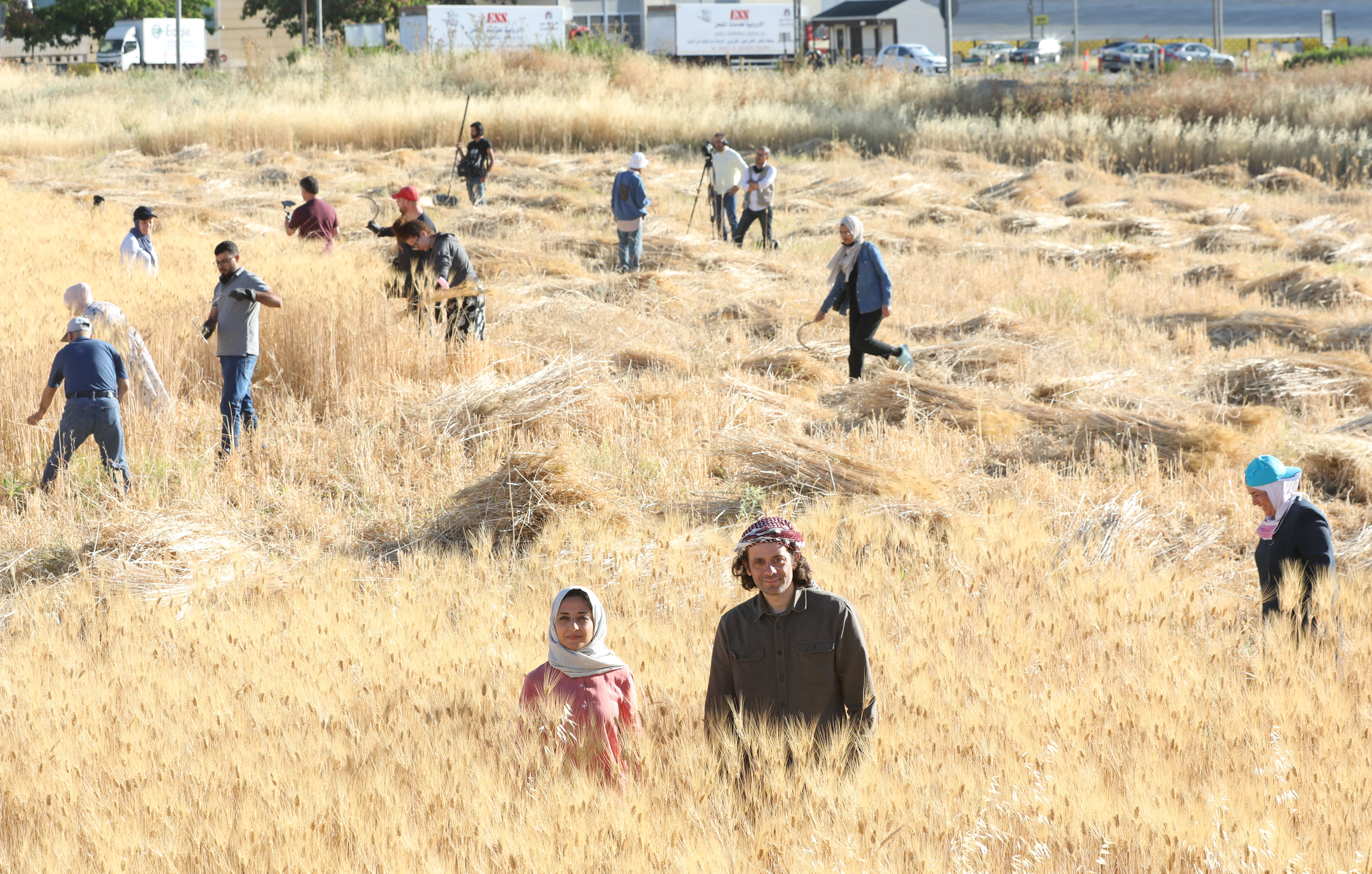 Lama Khatieb and Rabee Zureikat pose in a wheat field
