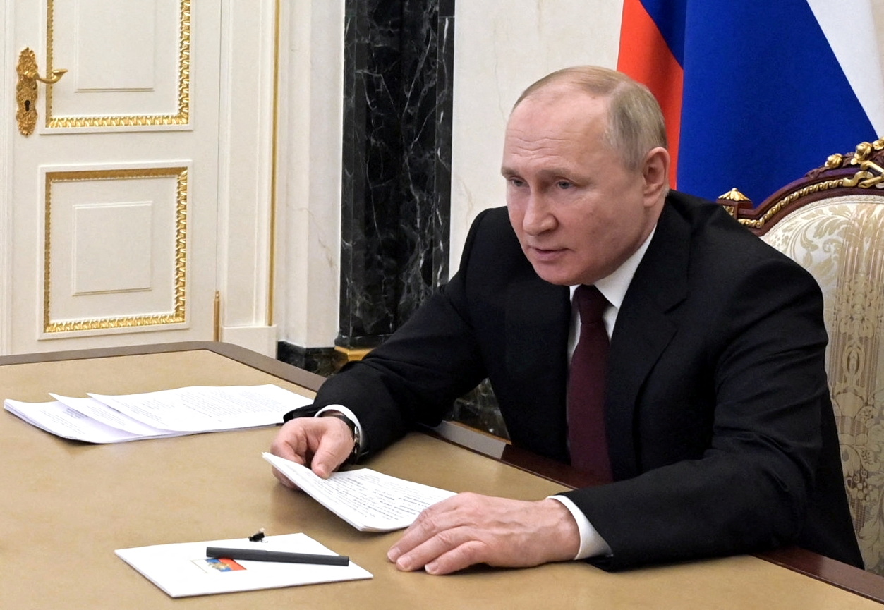 Russian President Vladimir Putin is seen signing a decree