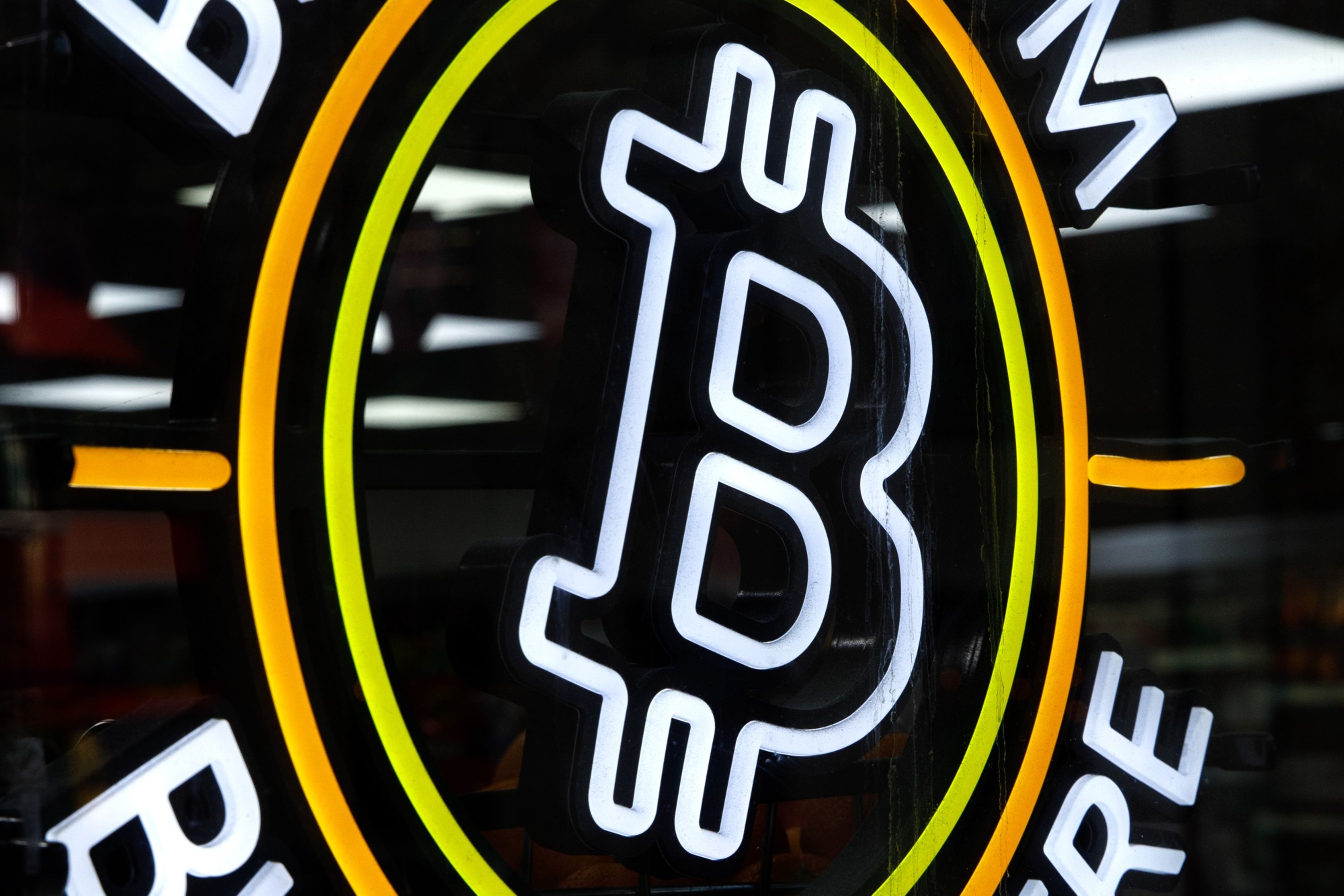 A sign advertising Bitcoin
