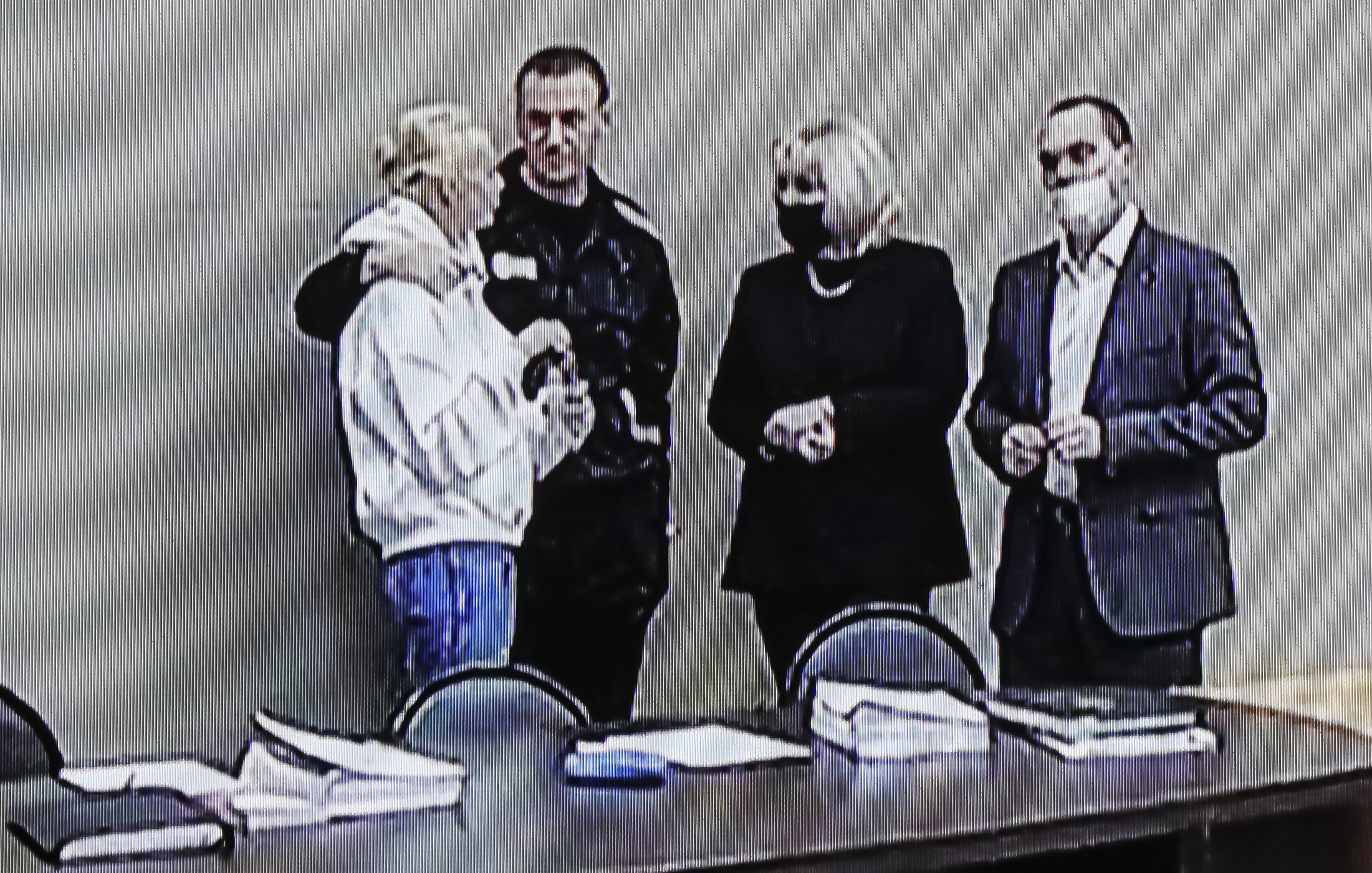 Russian opposition leader and activist Alexei Navalny and his wife Yulia Navalnaya (L) seen on a monitor screen during an offsite court session in the penal colony N2 (IK-2) in Pokrov, Vladimir region, Russia,