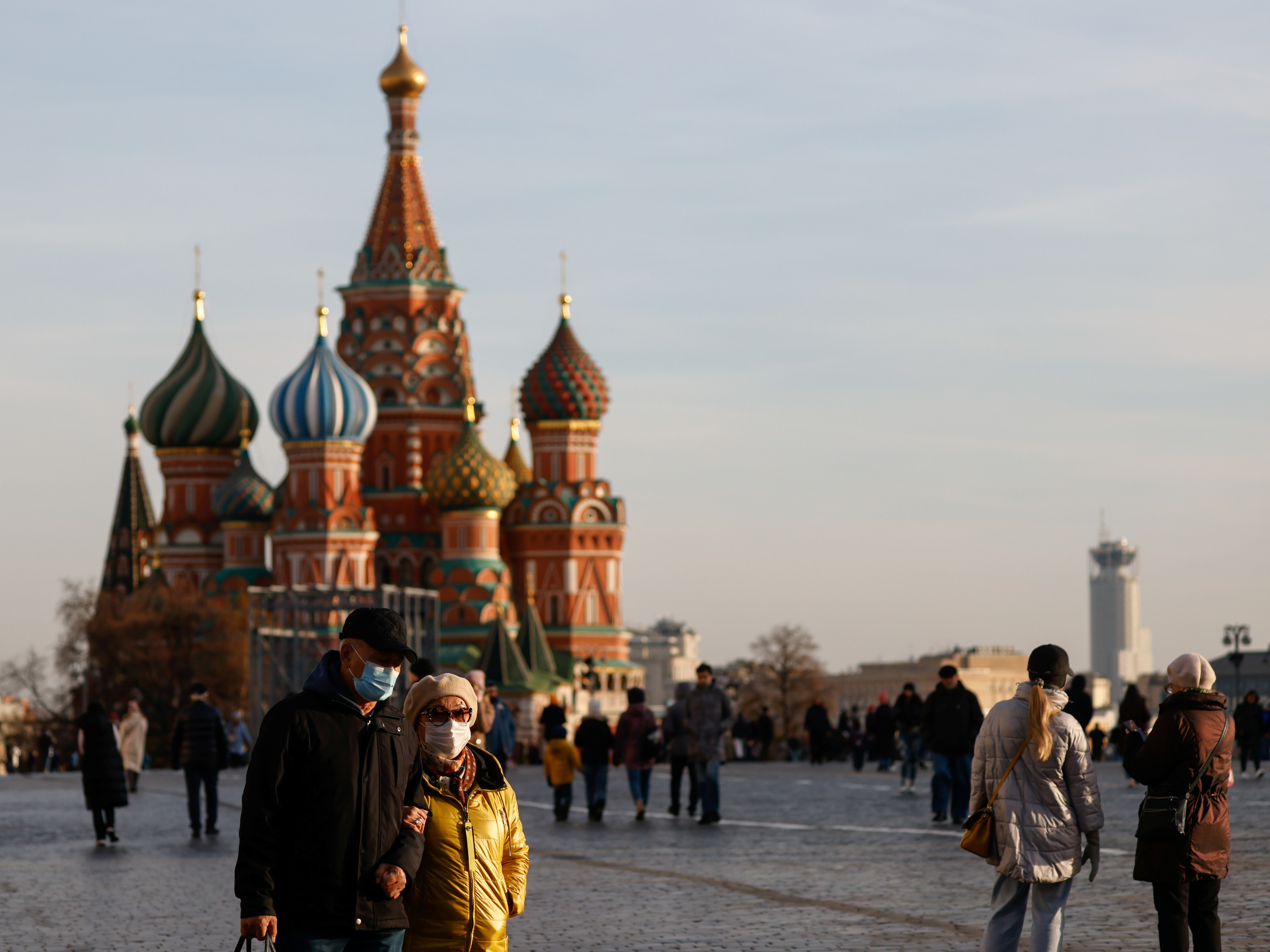 People wearing face masks walk across Red Square amid the outbreak of the coronavirus disease (COVID-19) in Moscow, Russia